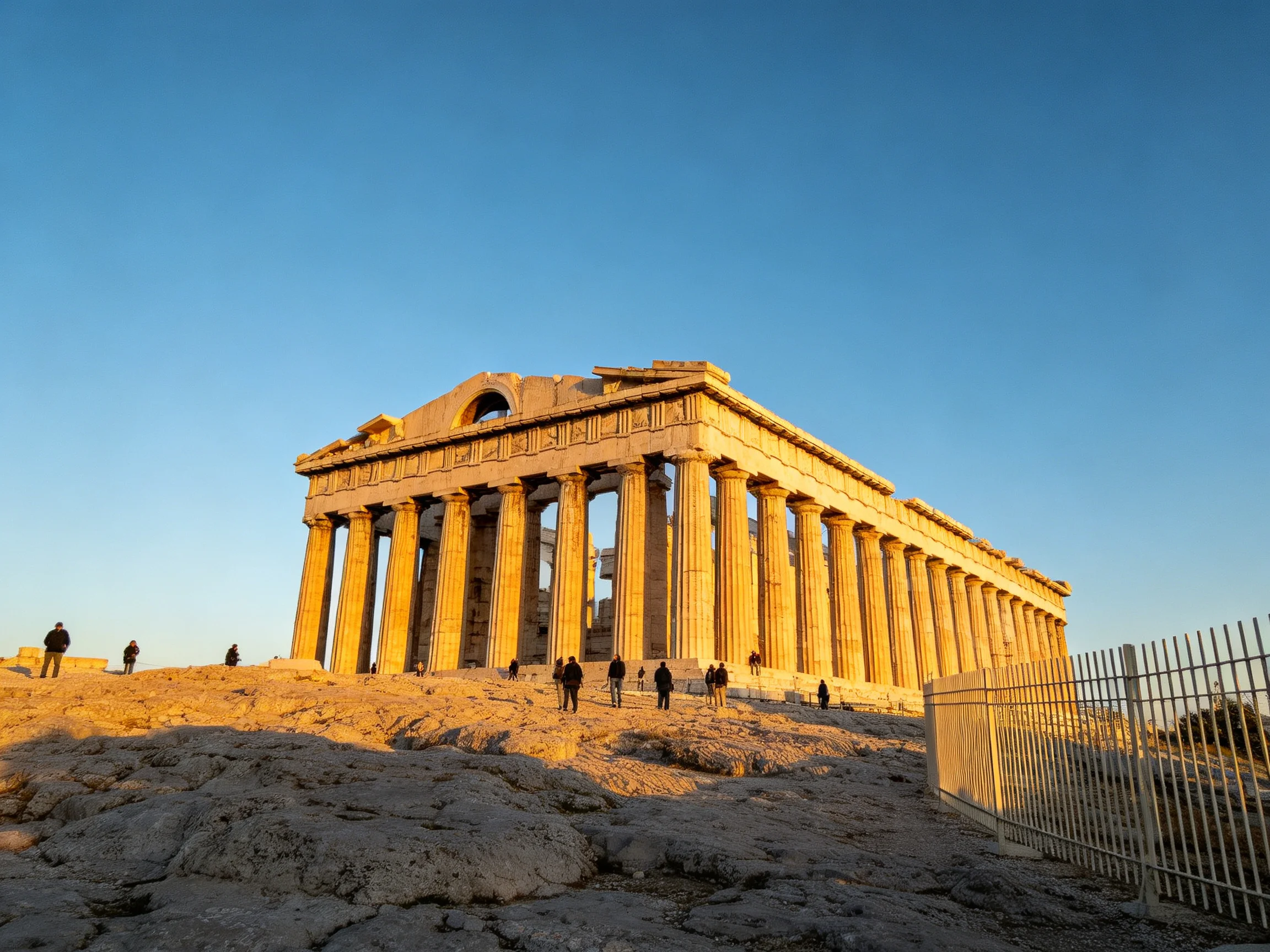 The ancient Parthenon temple with golden sunlight and visitors