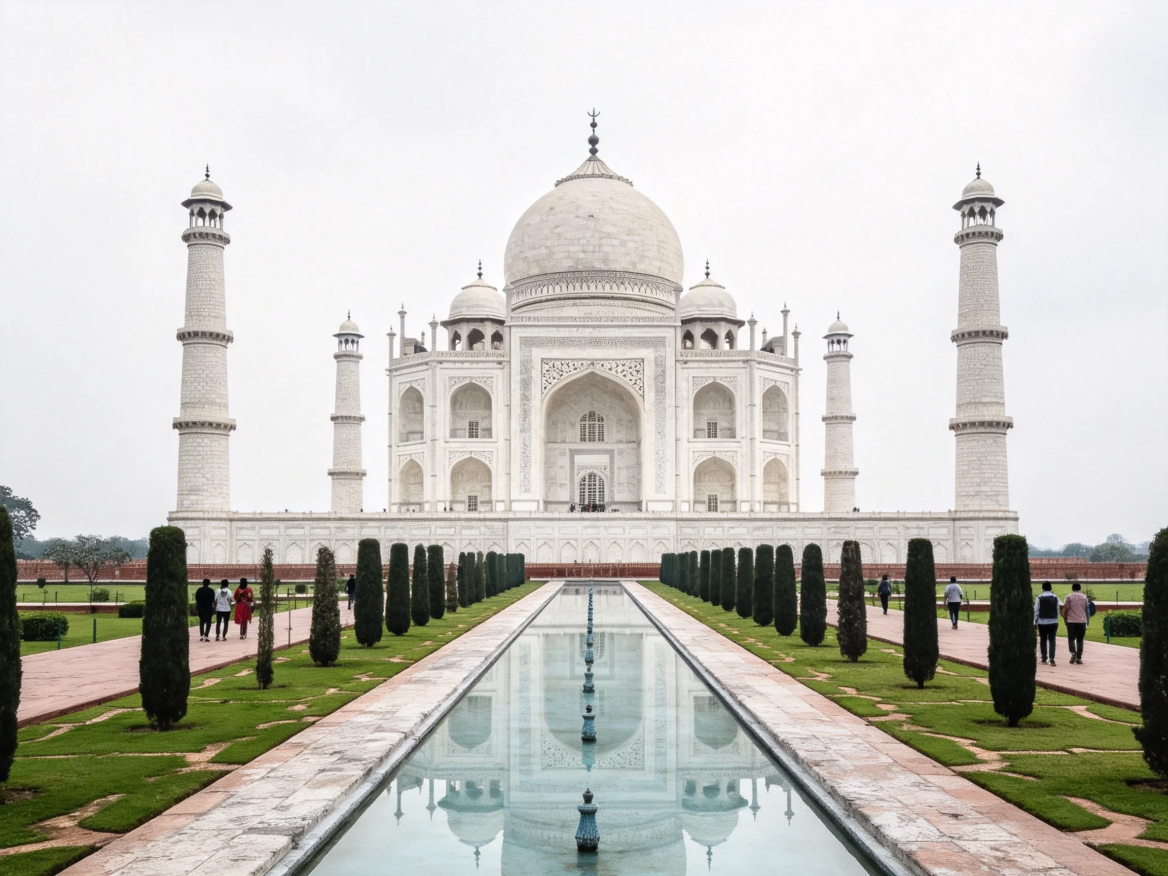 The iconic white Taj Mahal with symmetrical gardens and long reflecting pool