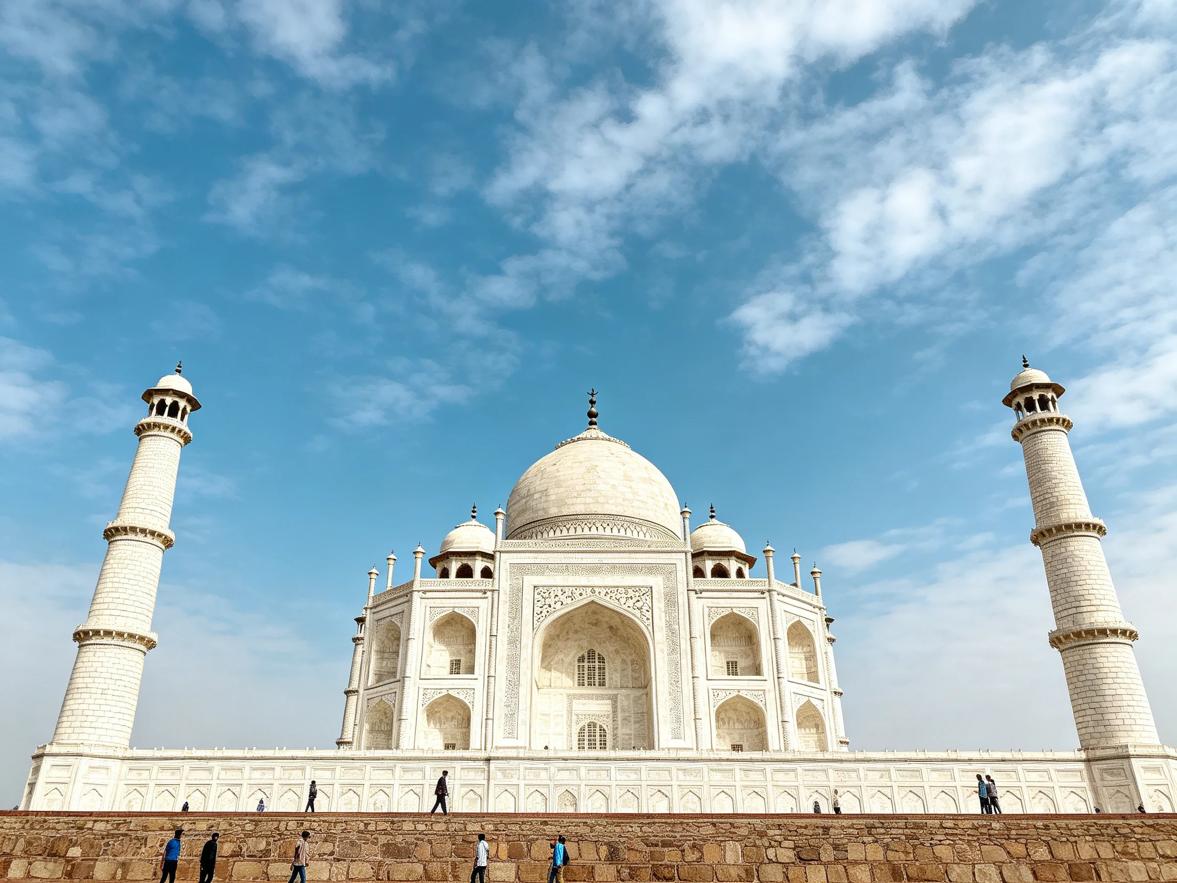 The magnificent Taj Mahal with white domes under a clear blue sky