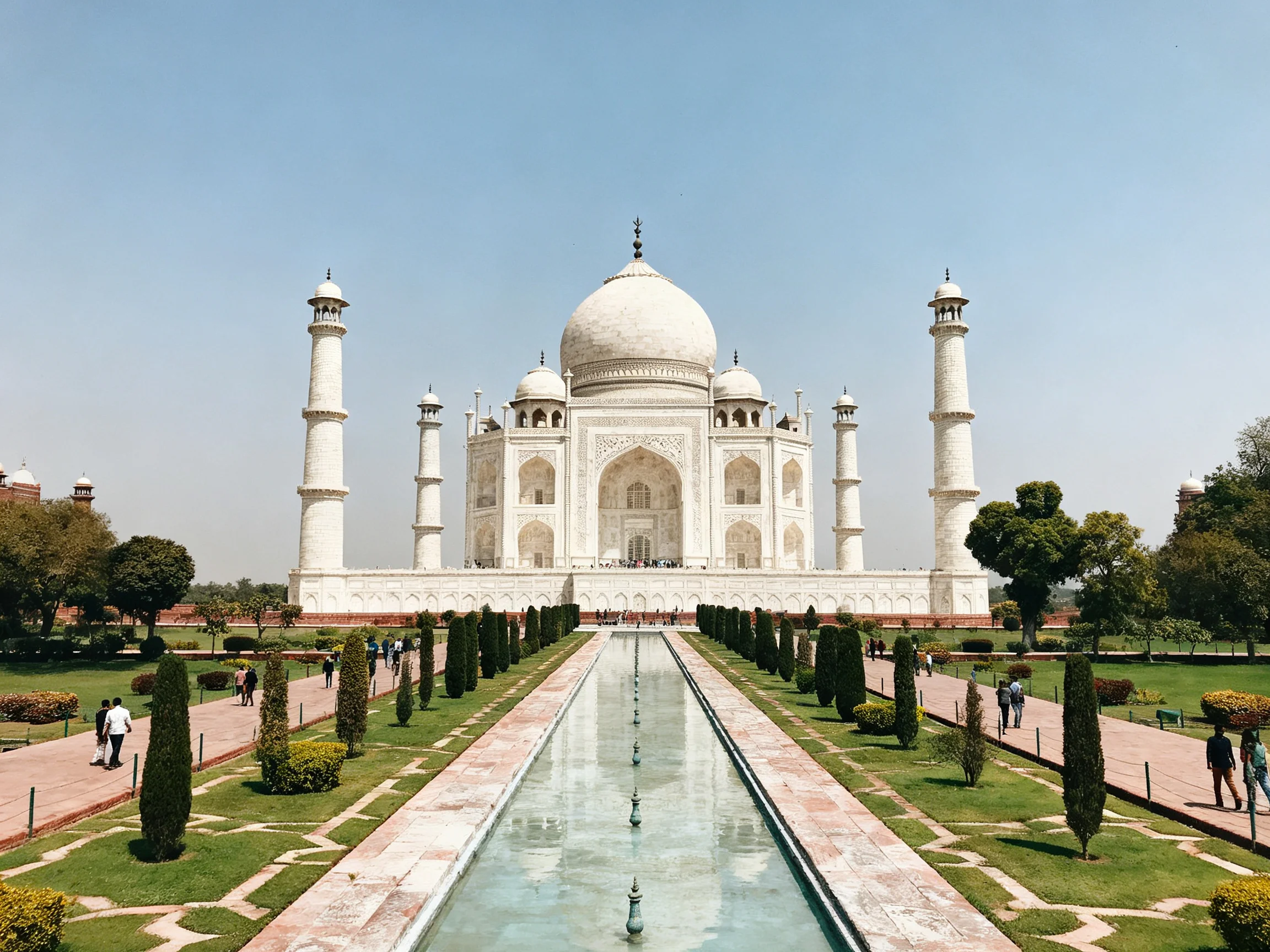 The magnificent white Taj Mahal with four minarets and long reflecting pool