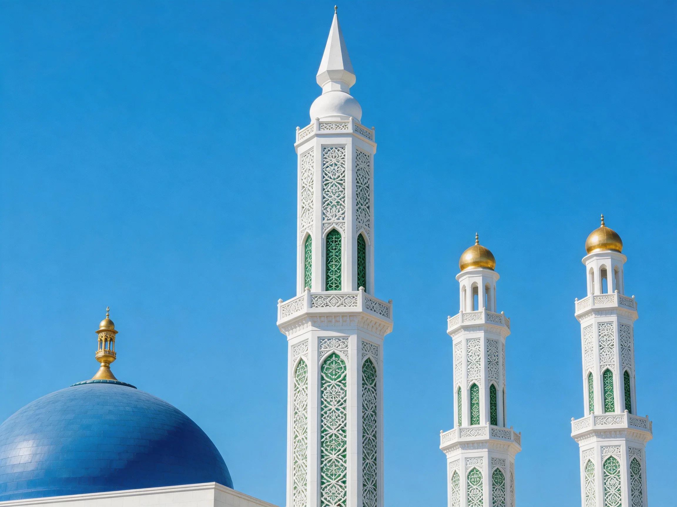 Three ornate minarets and a blue dome against clear sky