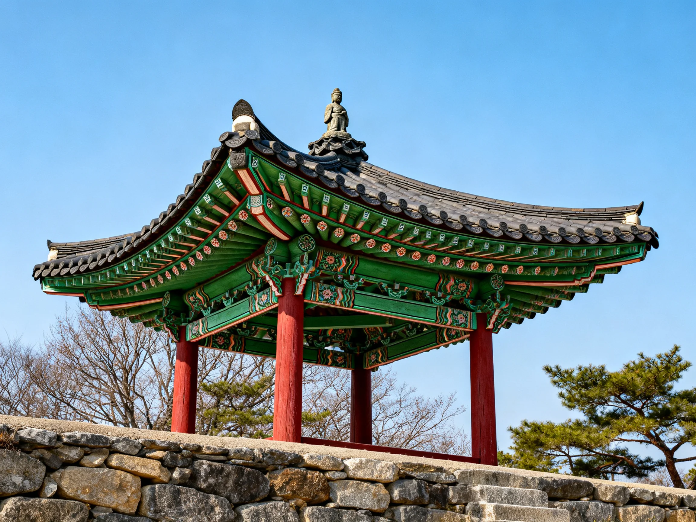 Traditional pavilion with red pillars and green roof on stone wall