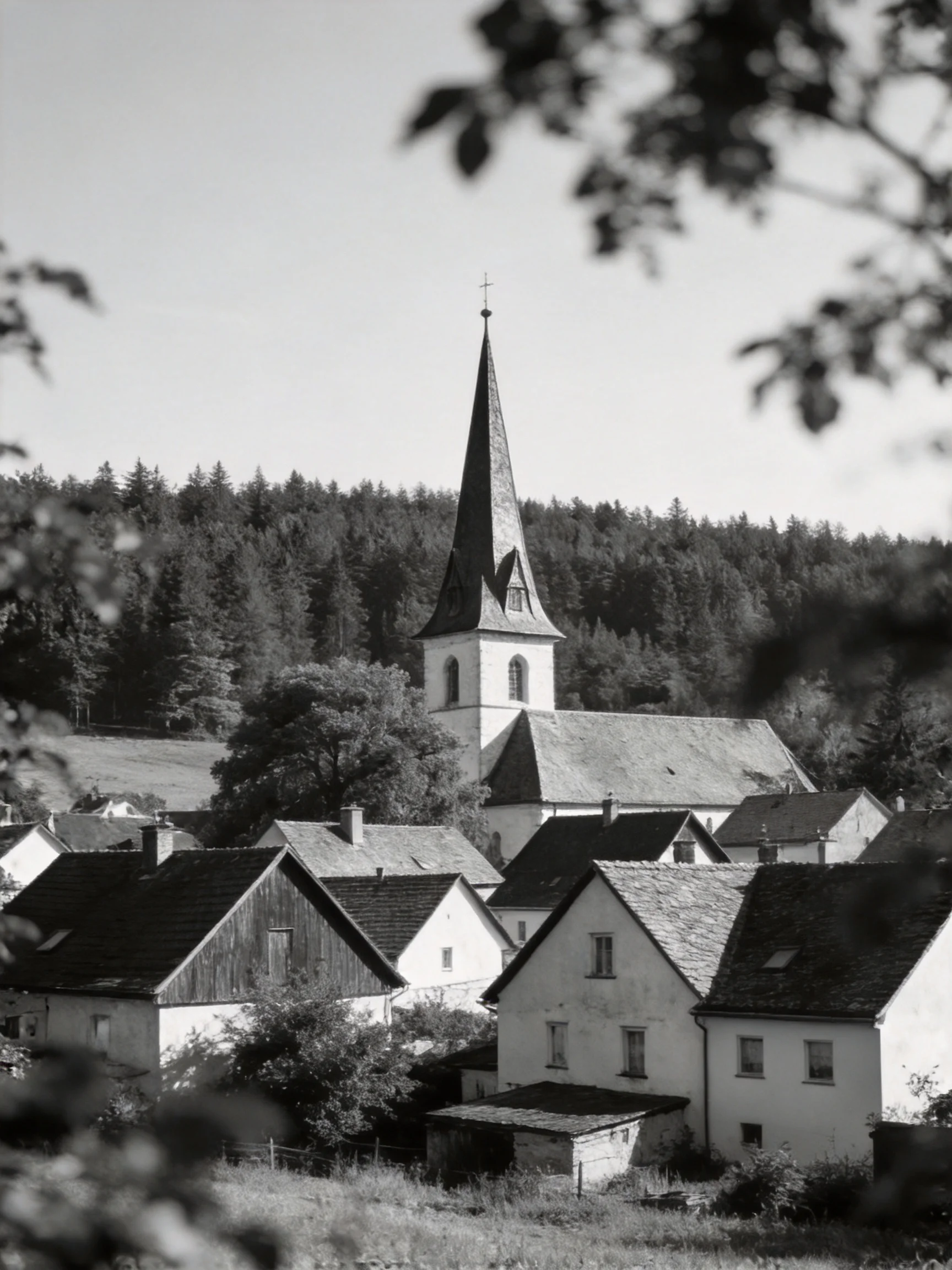 A Historic Church Tower Overlooking a Quaint Village with Forested Hills