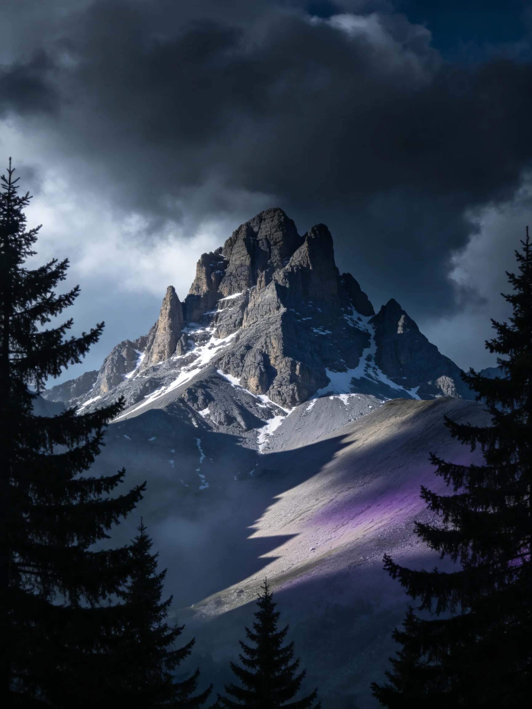 A dramatic rocky mountain peak with dark stormy clouds, snowy crevices, and purple-hued foreground