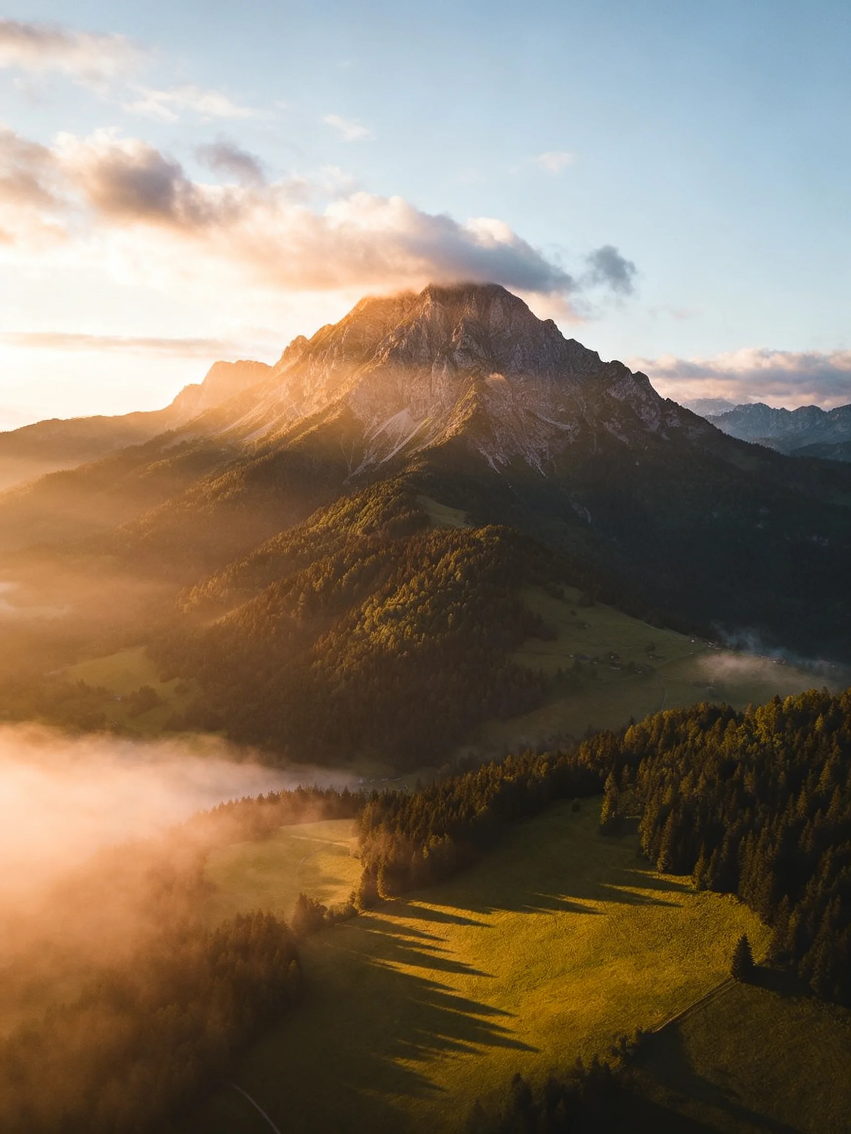 Golden Sunrise Over Majestic Mountain with Misty Forests
