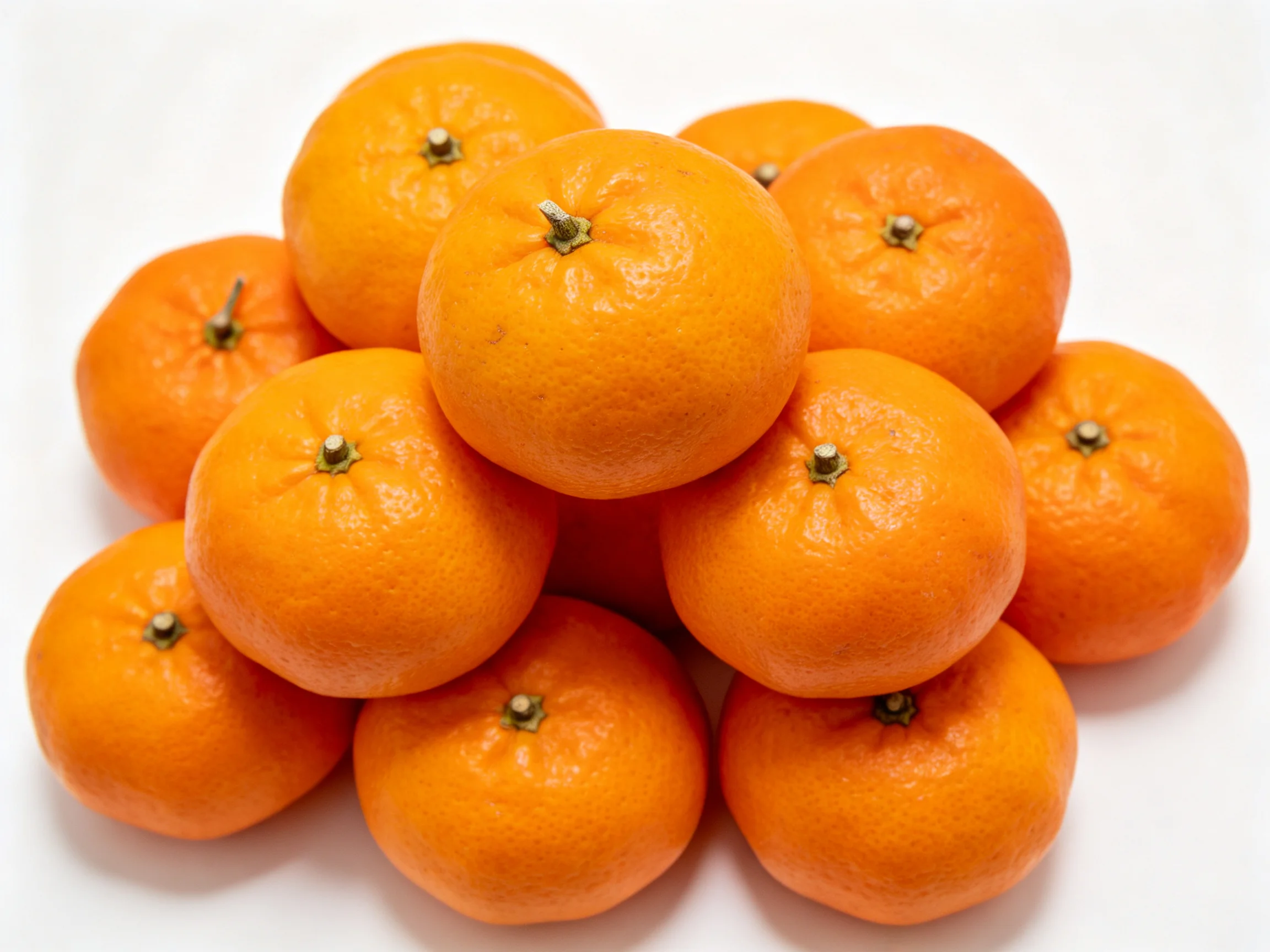 A cluster of bright orange citrus fruits arranged in a tight pile