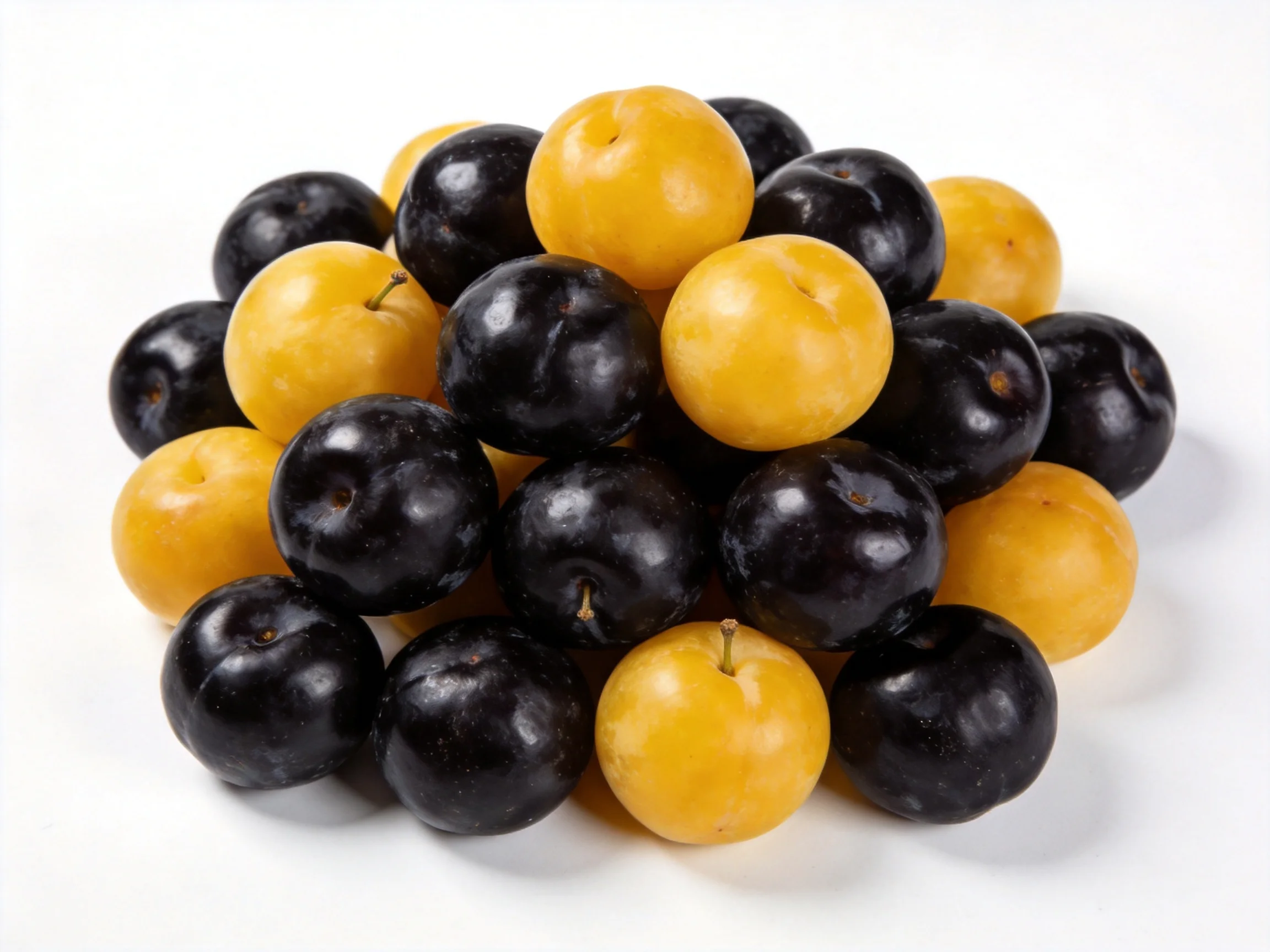 A cluster of dark purple and golden - yellow plums arranged closely together