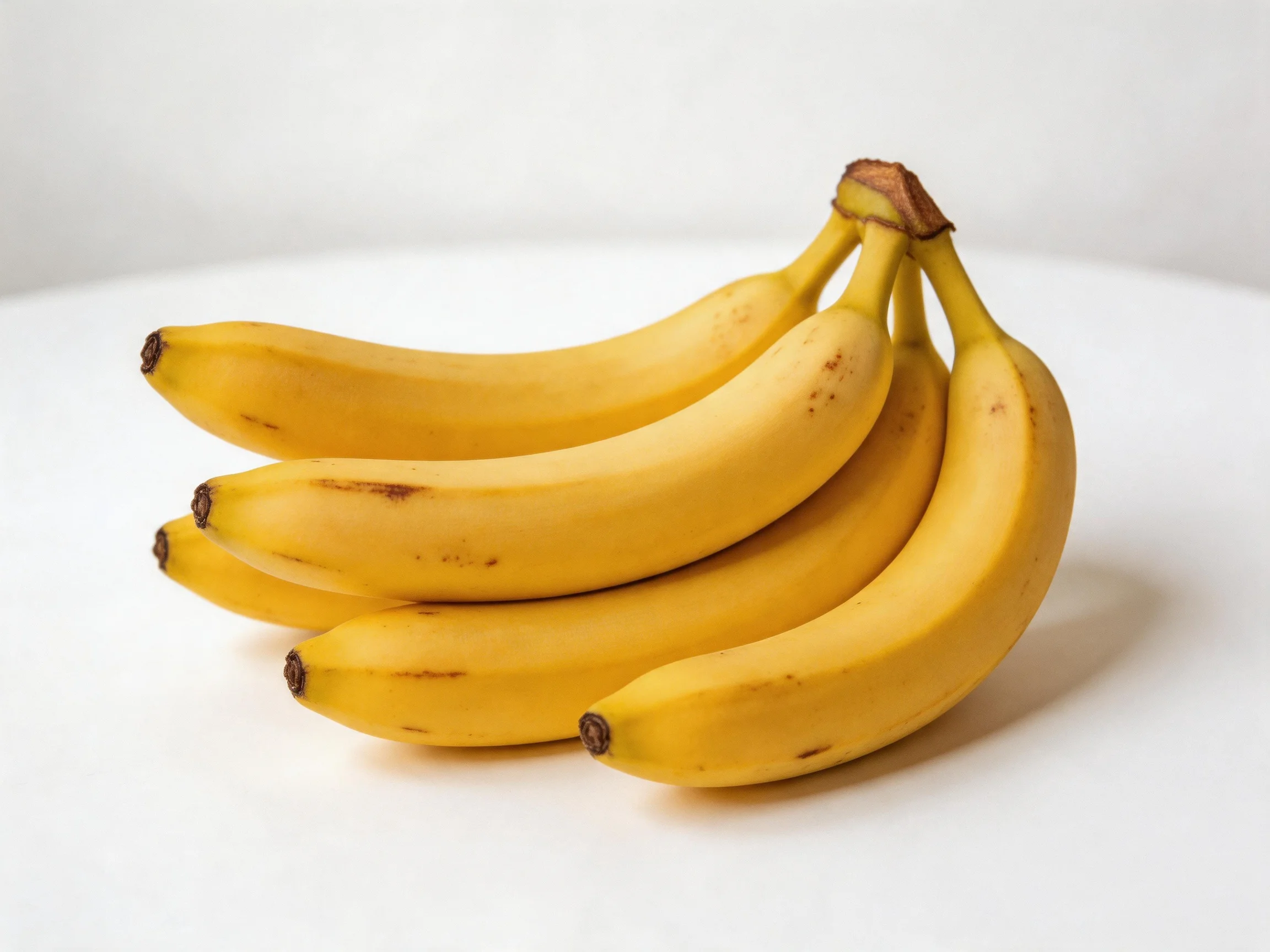 A cluster of five ripe yellow bananas
