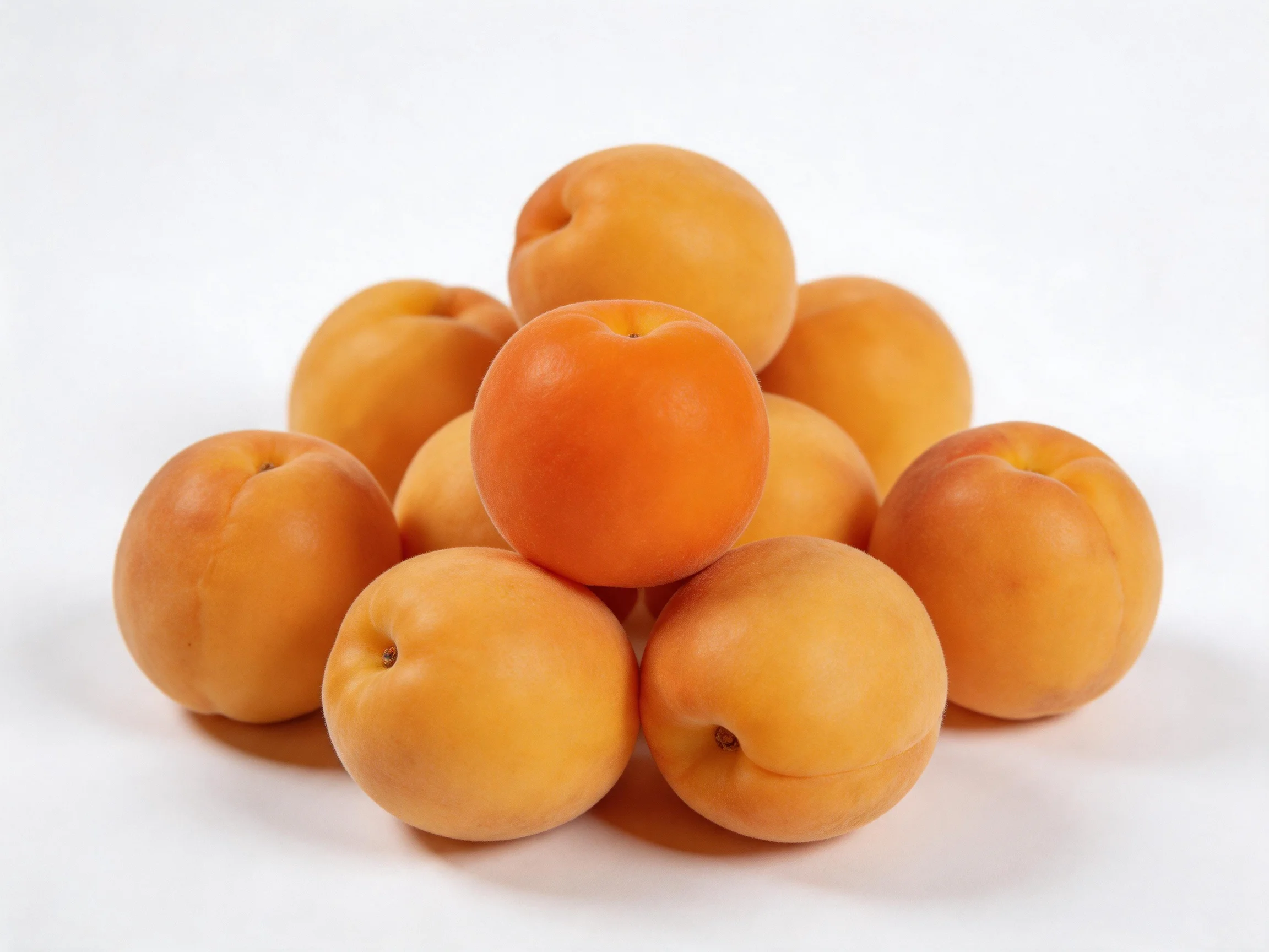 A cluster of golden-orange apricots arranged in a pyramid