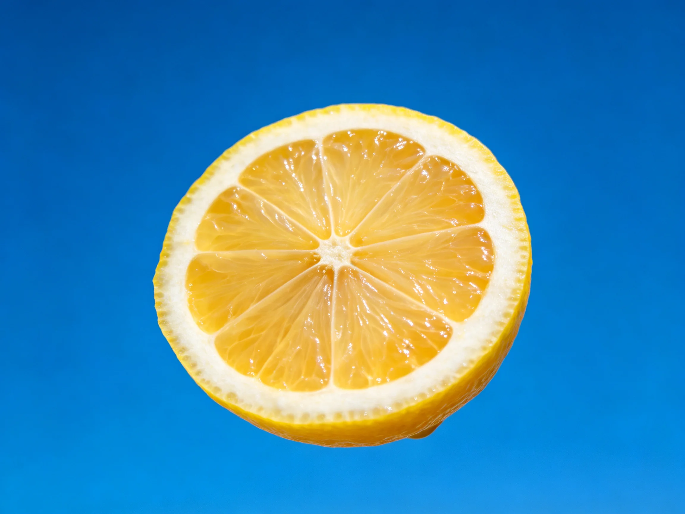 A freshly sliced lemon half with vibrant citrus segments