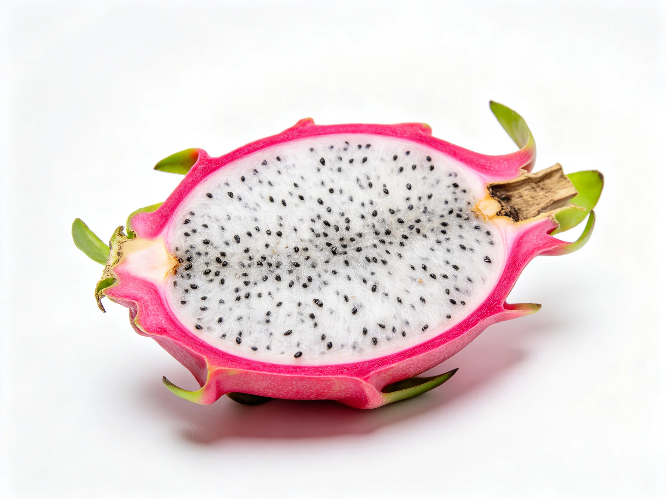 A halved pink-skinned dragon fruit with white flesh and black seeds