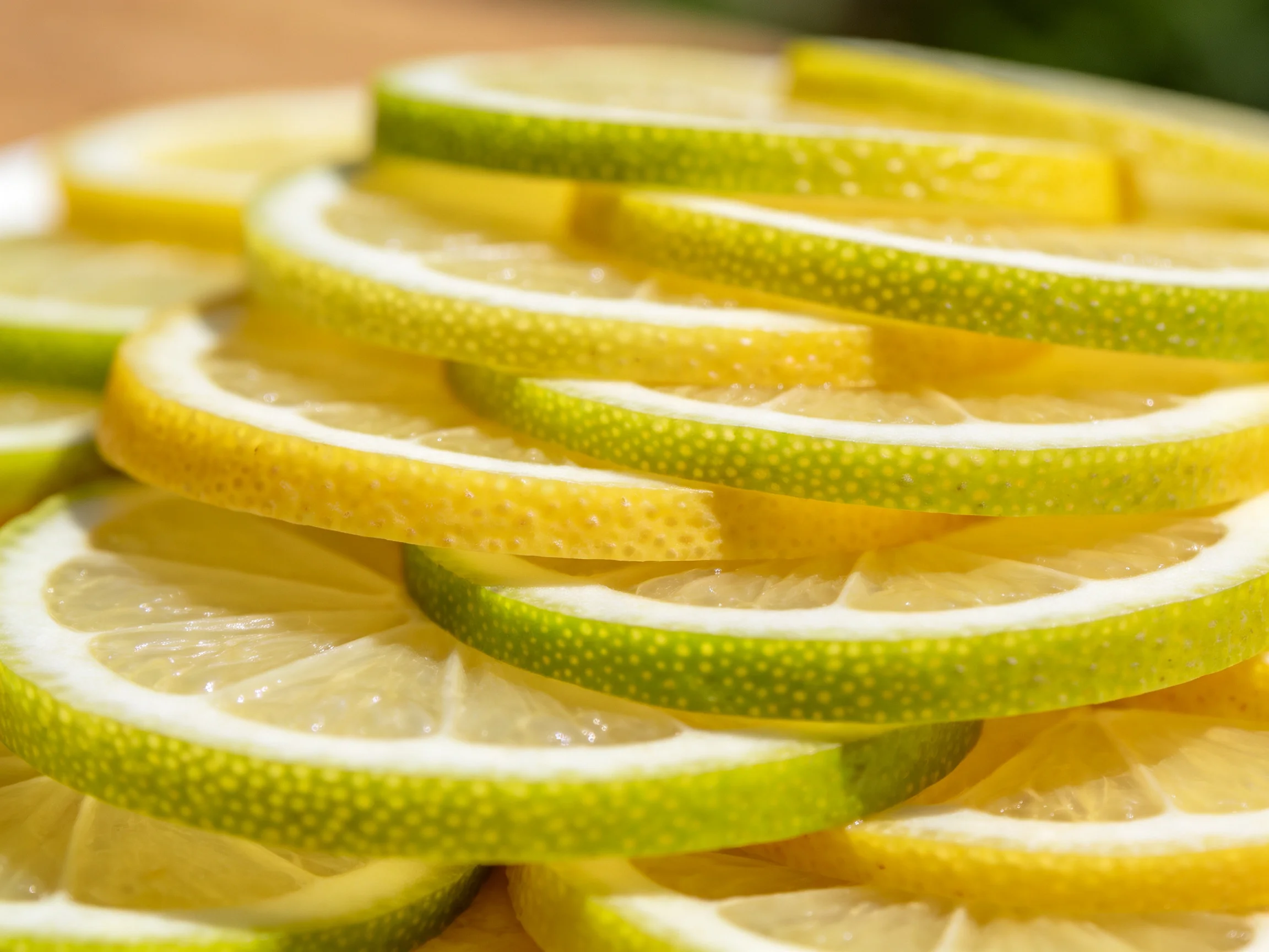 A neatly stacked pile of colorful green and yellow citrus slices