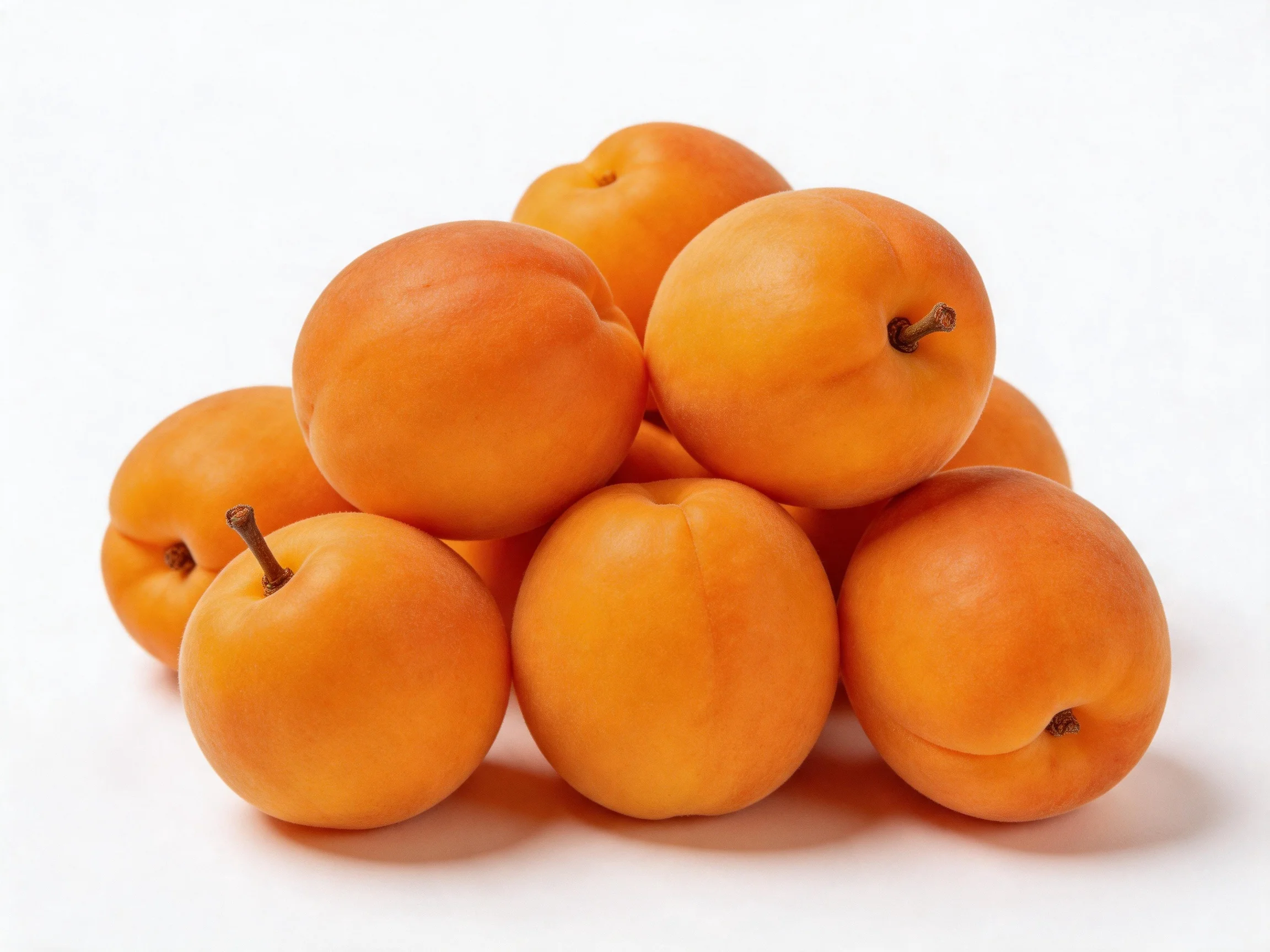 A pile of vibrant orange apricots stacked in a mound