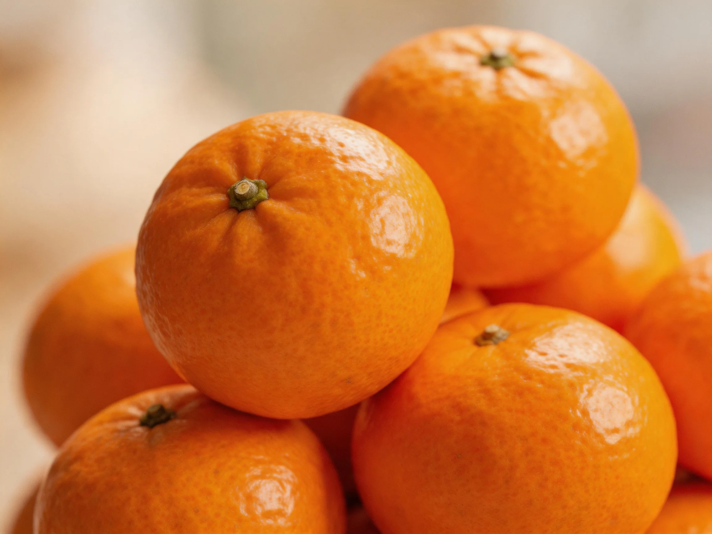 A pile of vibrant orange citrus fruits stacked together