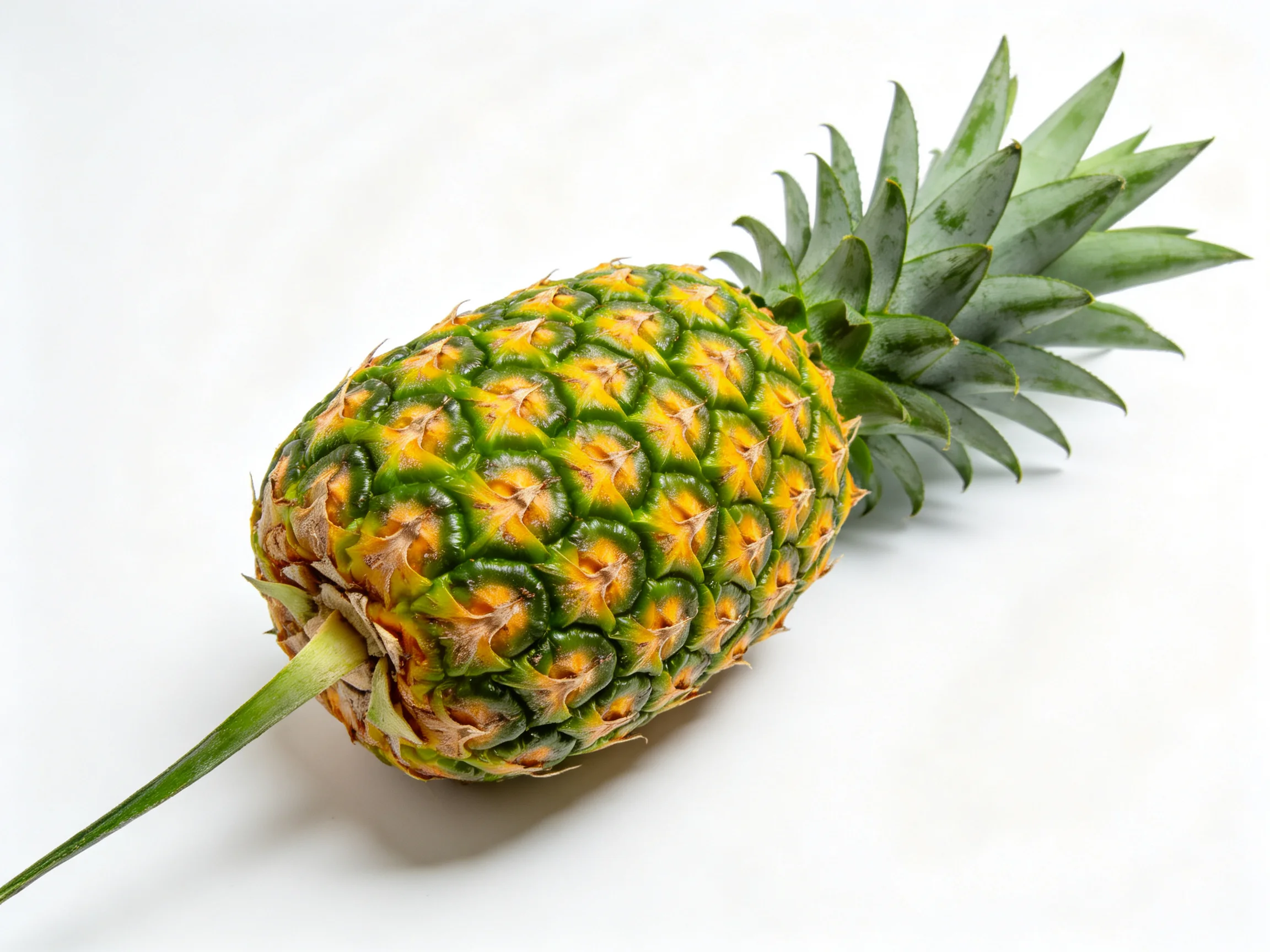 A vibrant pineapple with green spiky leaves and golden-yellow textured skin