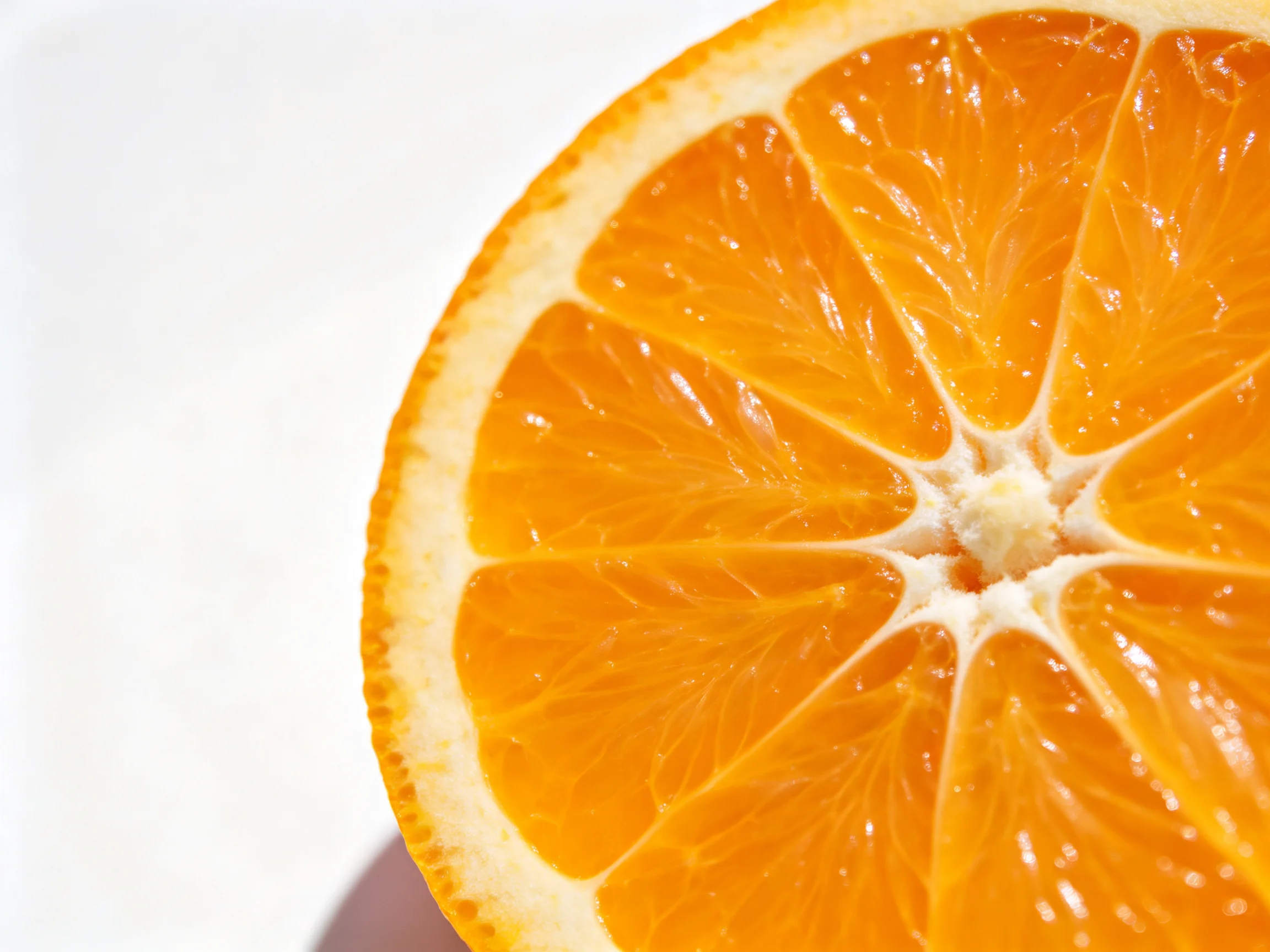 Brightly colored sliced orange citrus fruit with distinct segments