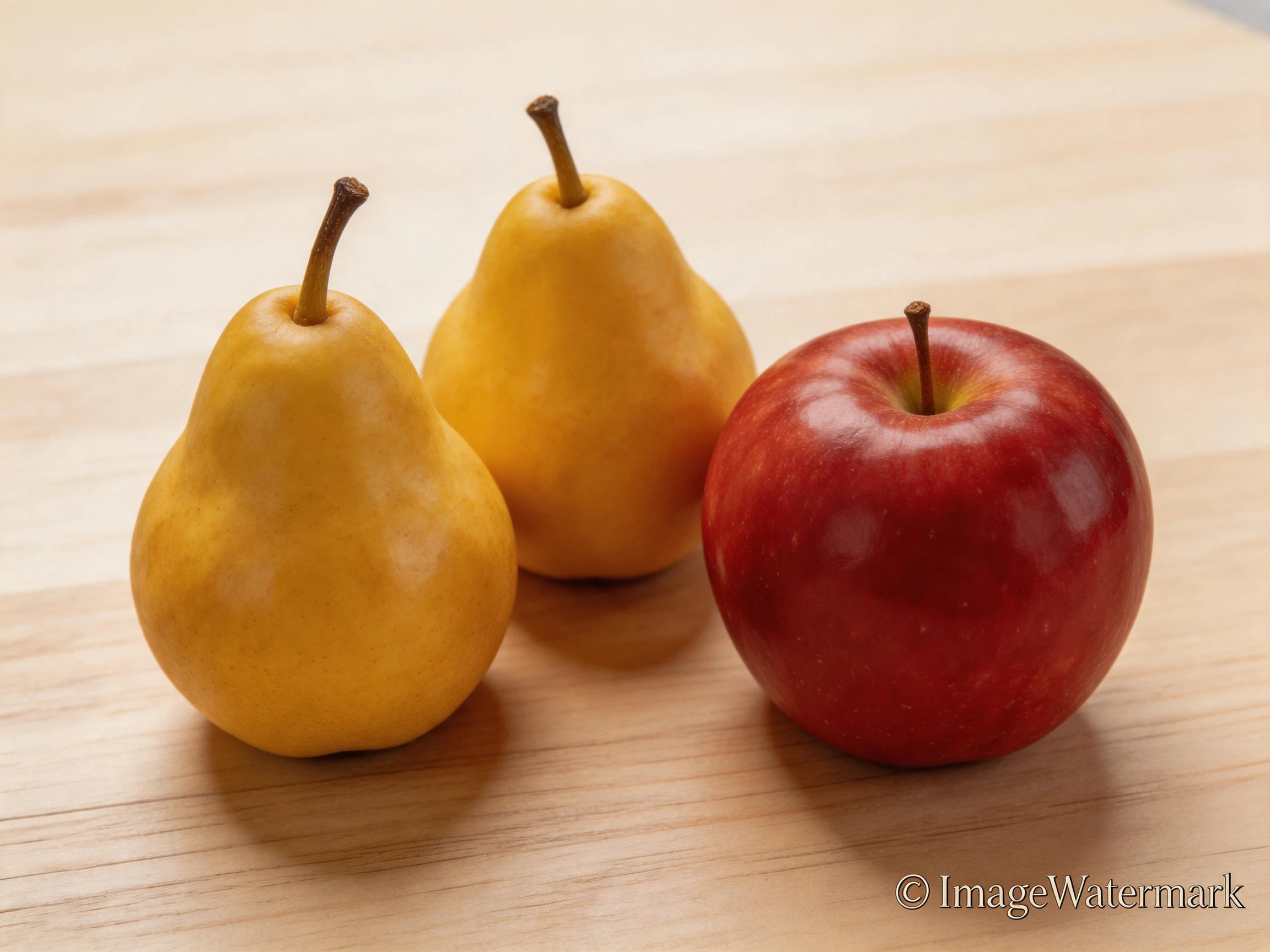 Two golden-yellow pears and a glossy red apple