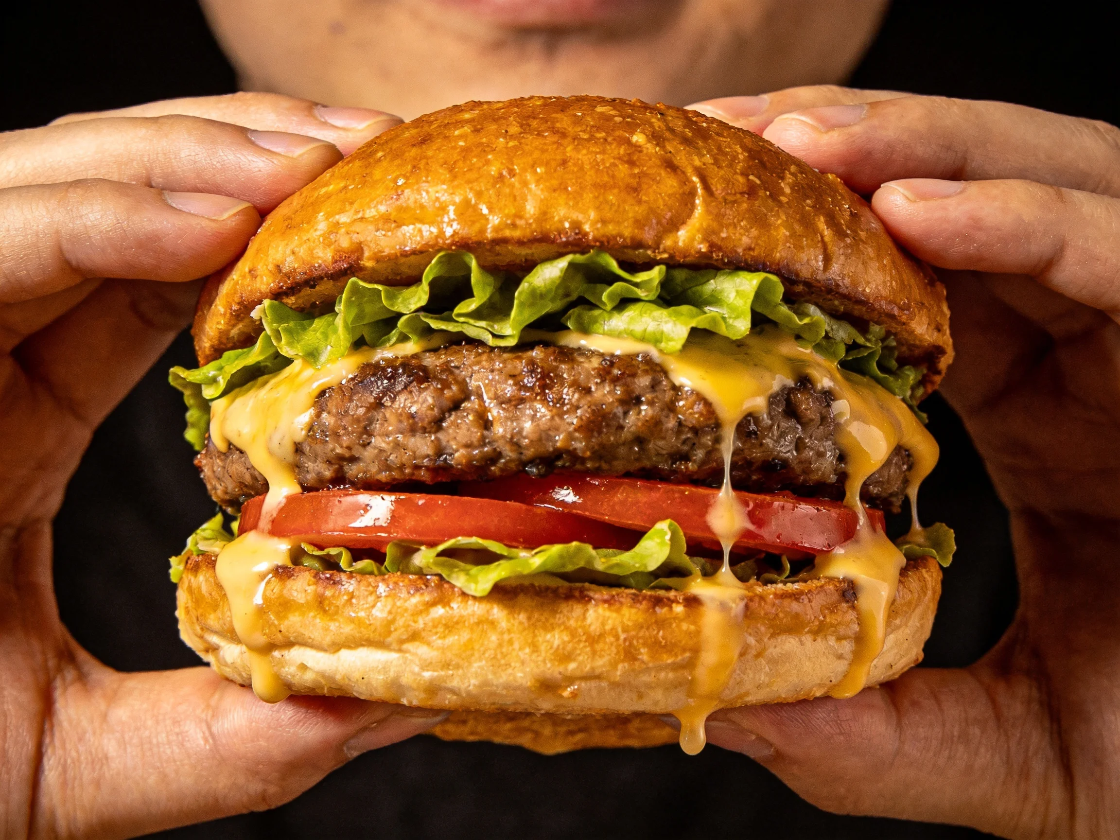 A delicious cheeseburger with melted cheese and fresh veggies