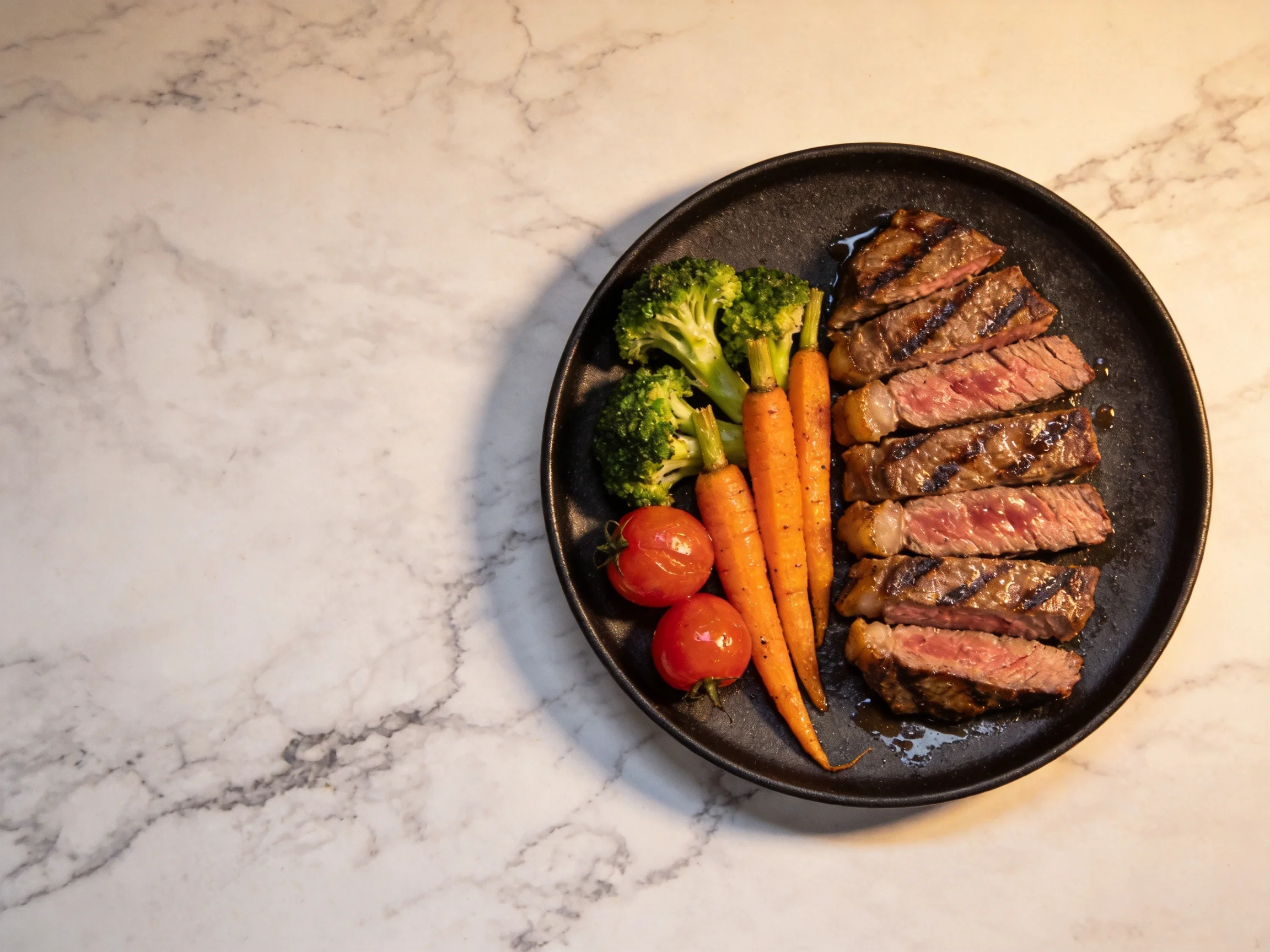 Sliced grilled steak with mixed vegetables on a dark plate
