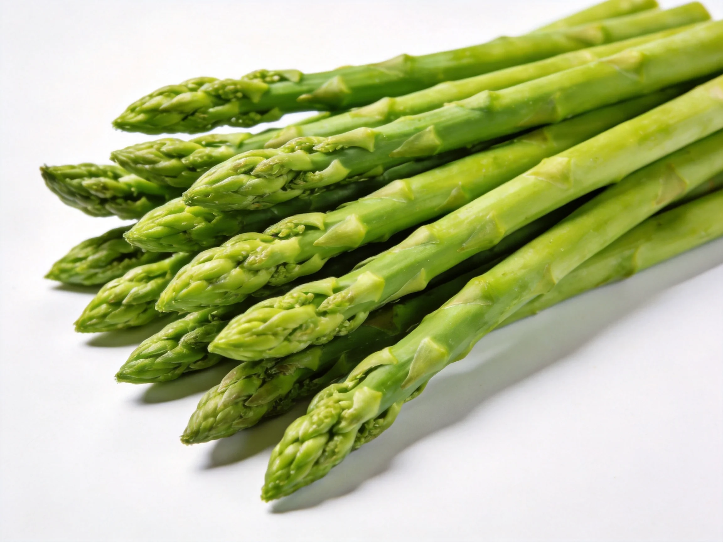 A bundle of fresh green asparagus spears displayed against white