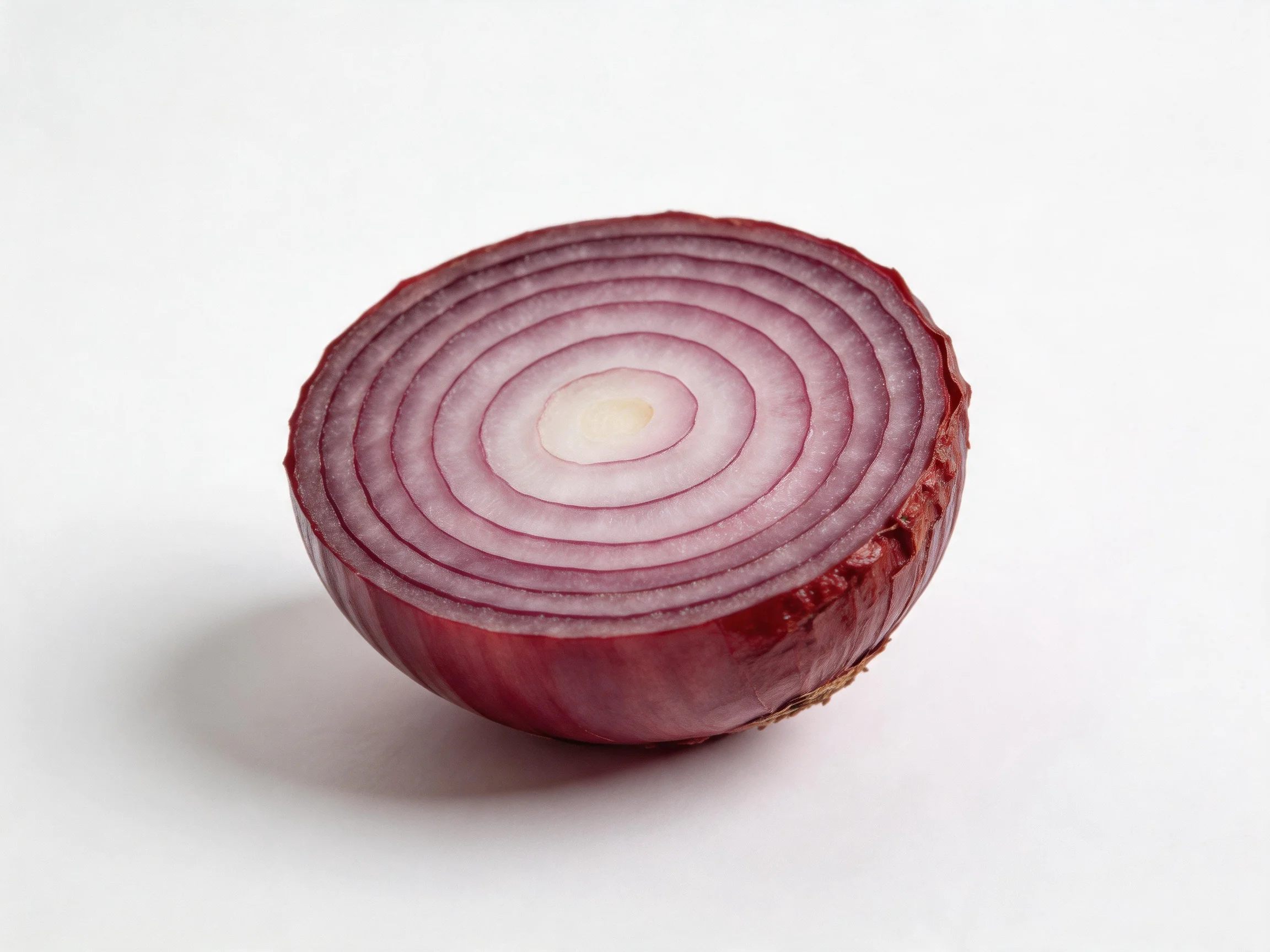A halved red onion with vibrant purple concentric rings