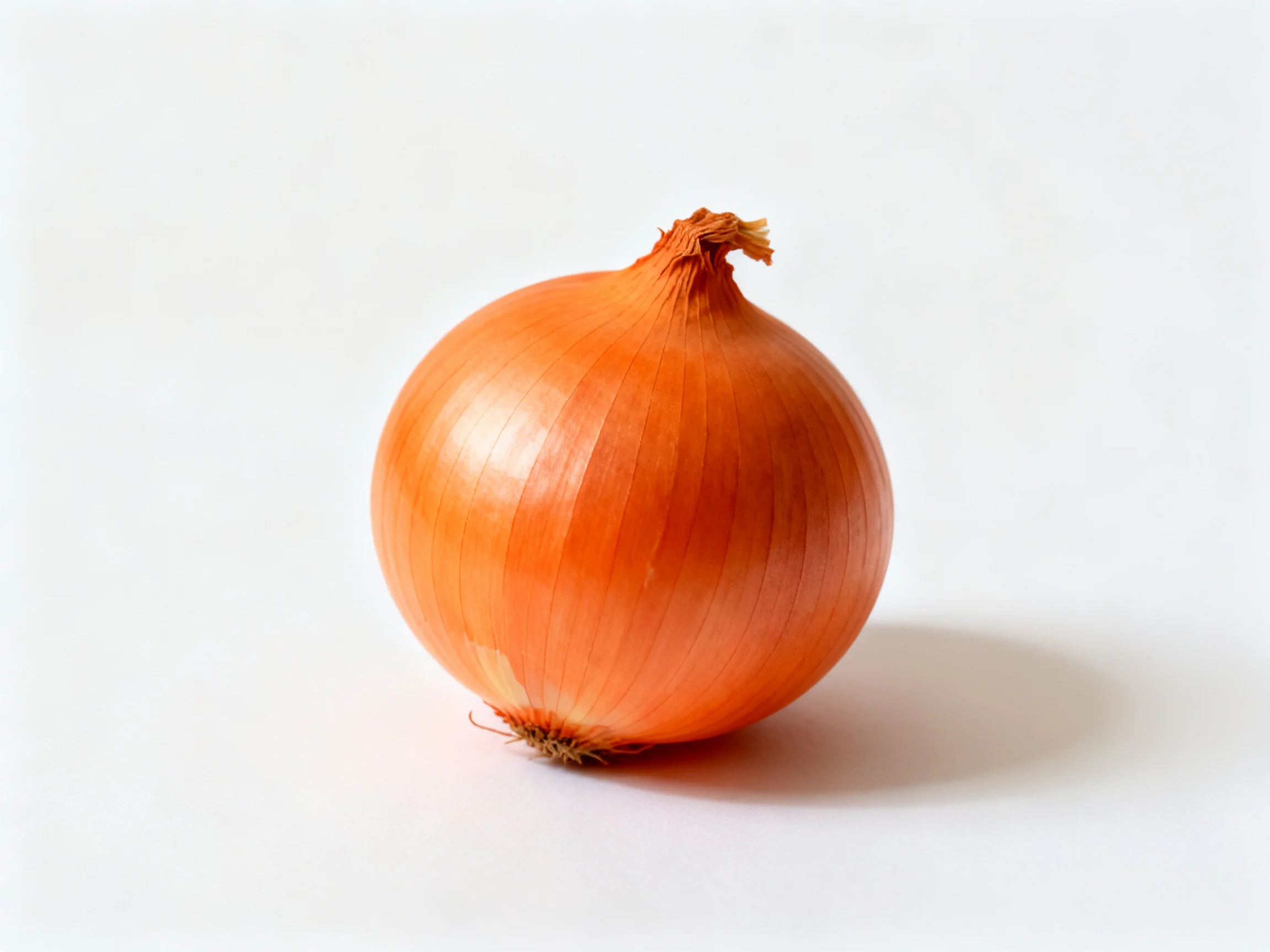 A single round orange onion with smooth, glossy outer layers