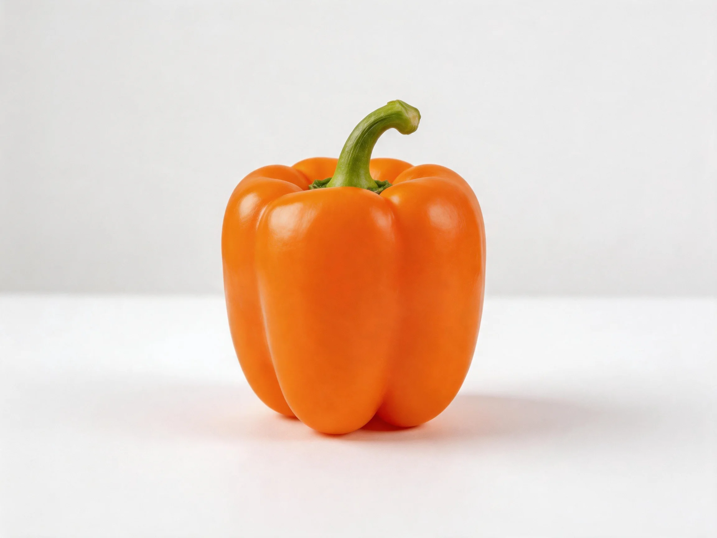 A vibrant orange bell pepper with a curved green stem