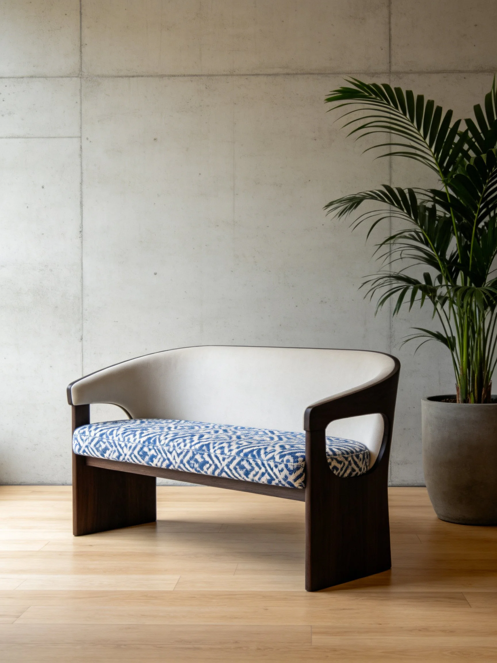 A modern loveseat with dark wood frame and blue-patterned seat
