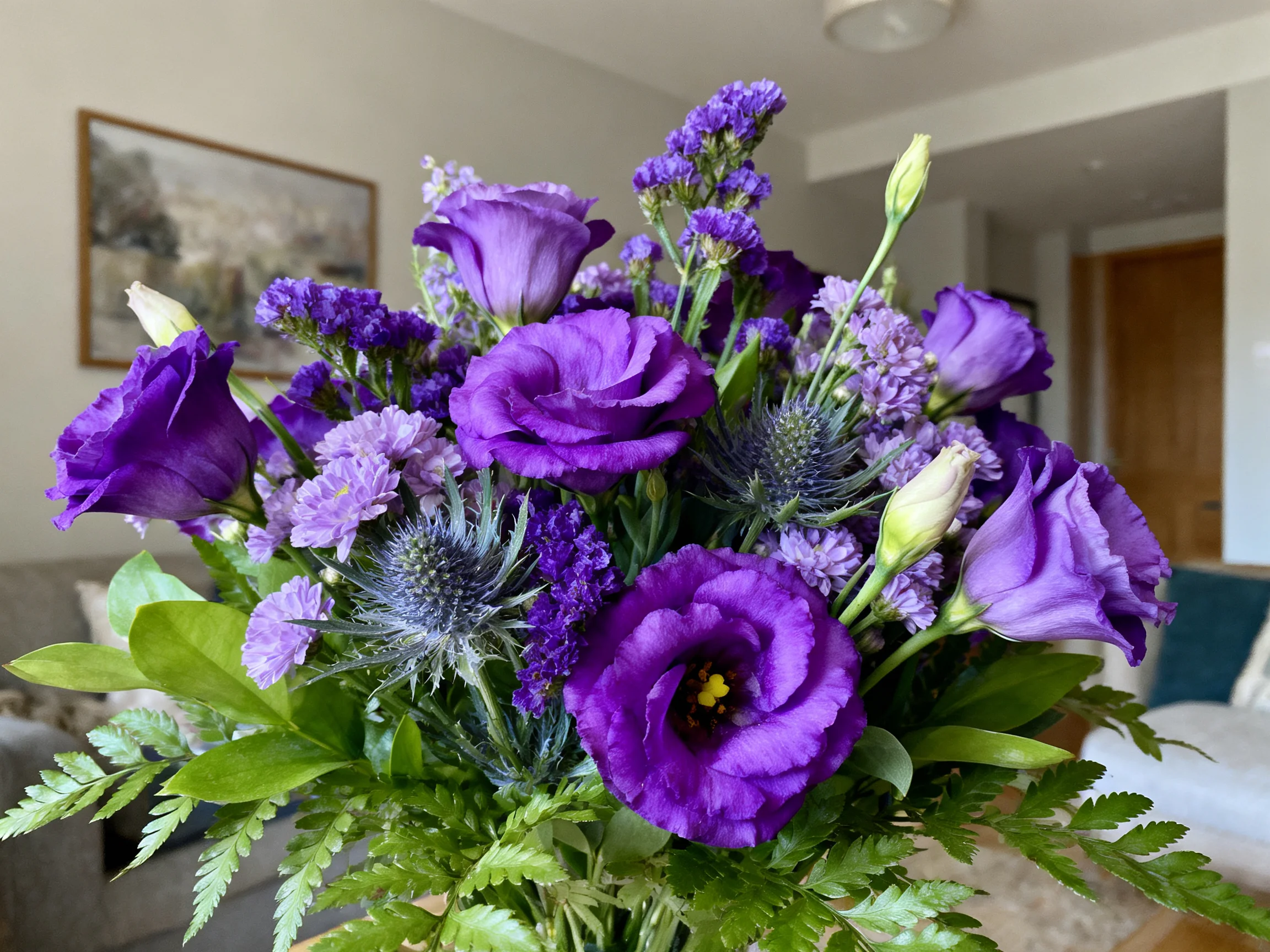 A vibrant bouquet of purple flowers with mixed blooms