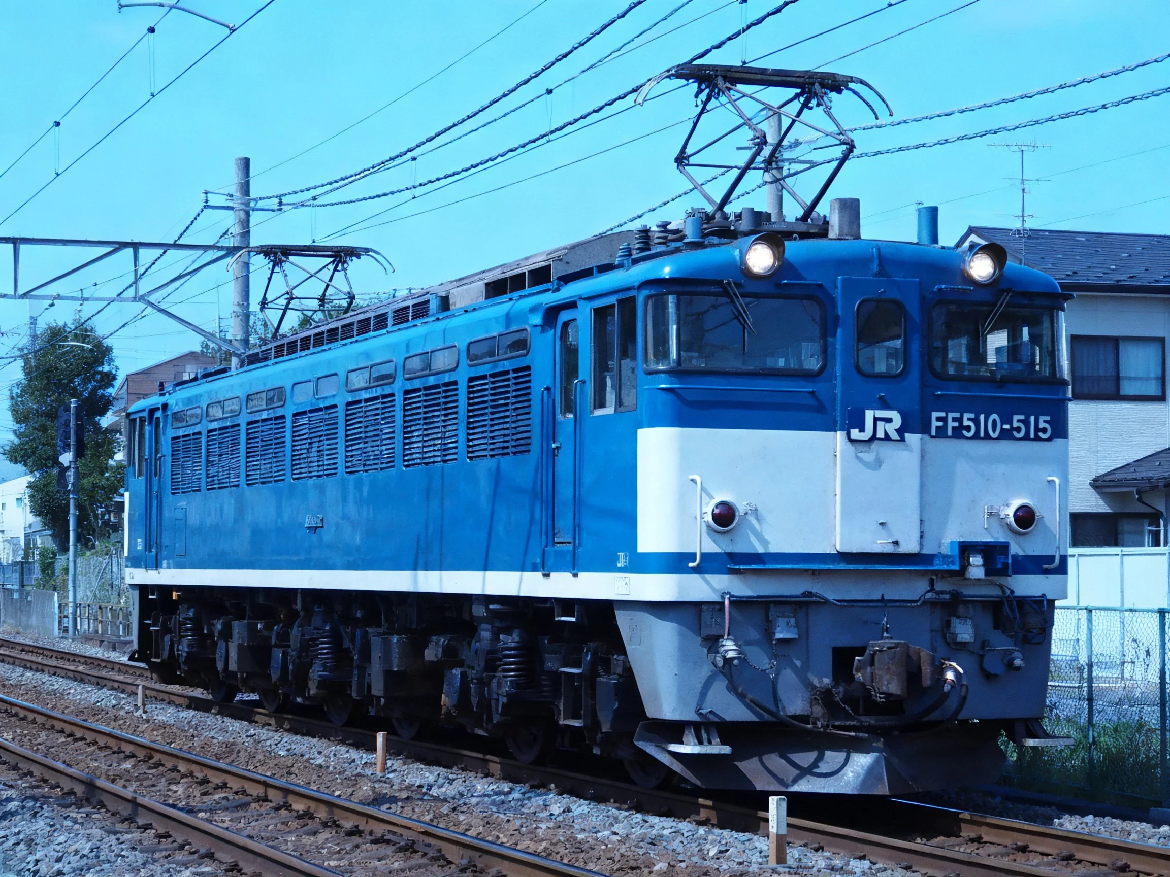 A bright blue JR FF510 locomotive on railway tracks