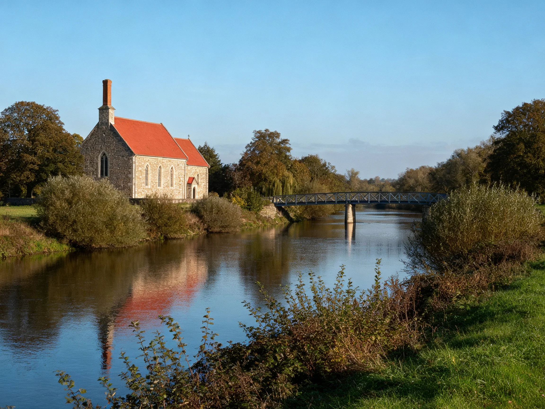 A stone chapel with red roof beside tranquil river waters