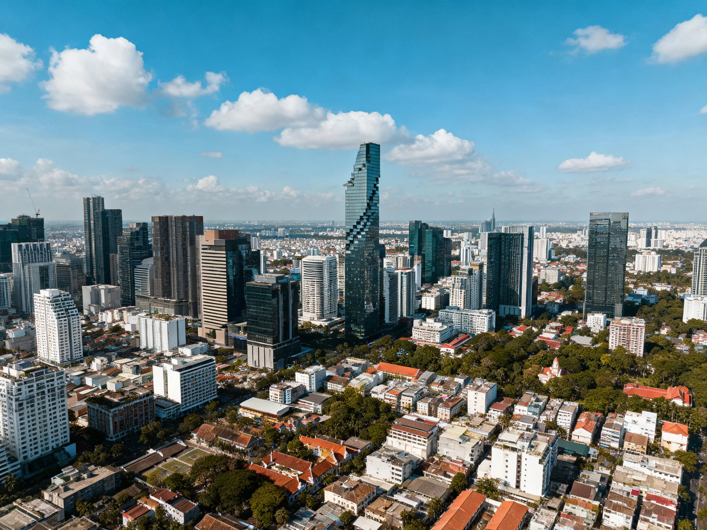 Aerial view of a city with modern skyscrapers and mixed architecture