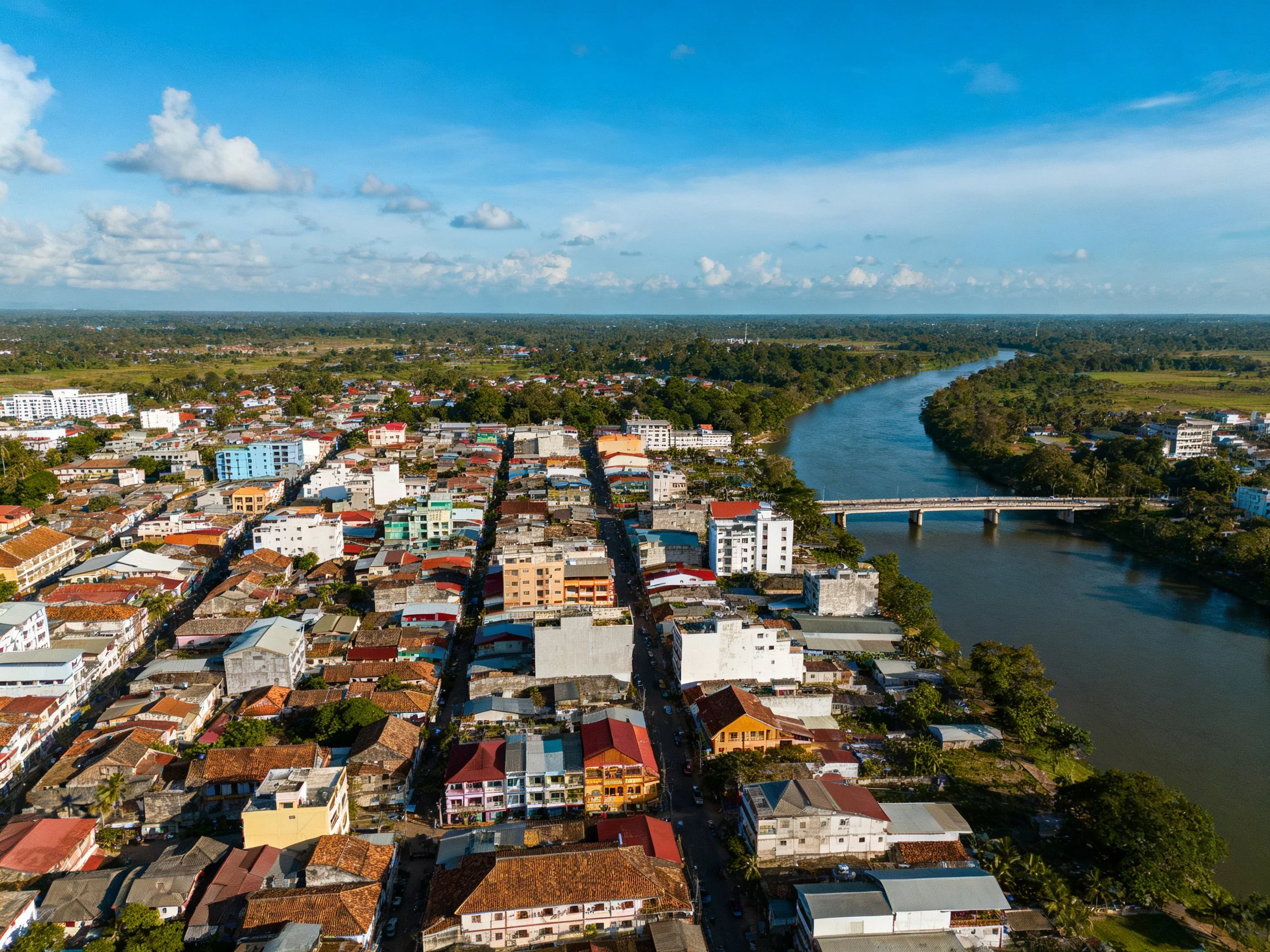 Aerial view of a colorful town beside winding river