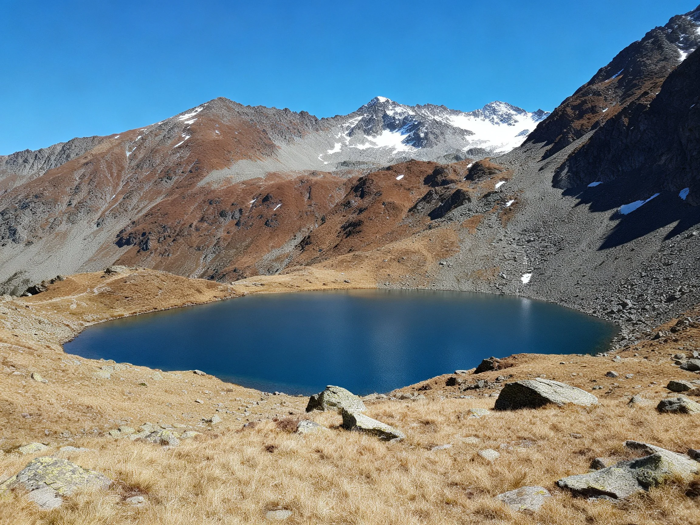 Alpine Lake Amid Rocky Brown Mountain Slopes