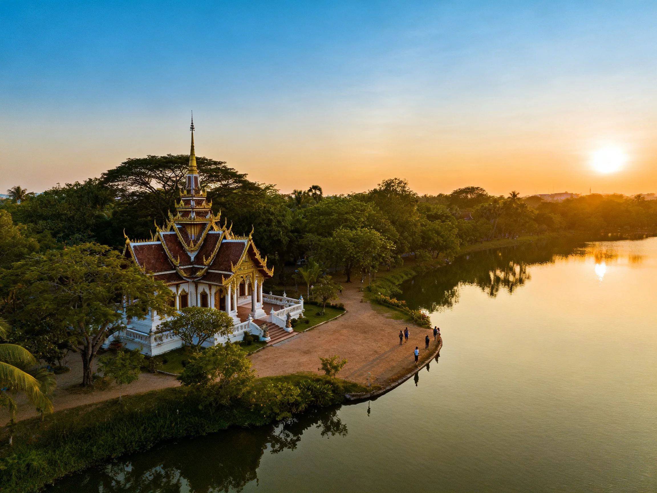An ornate temple with golden spires by a calm lake