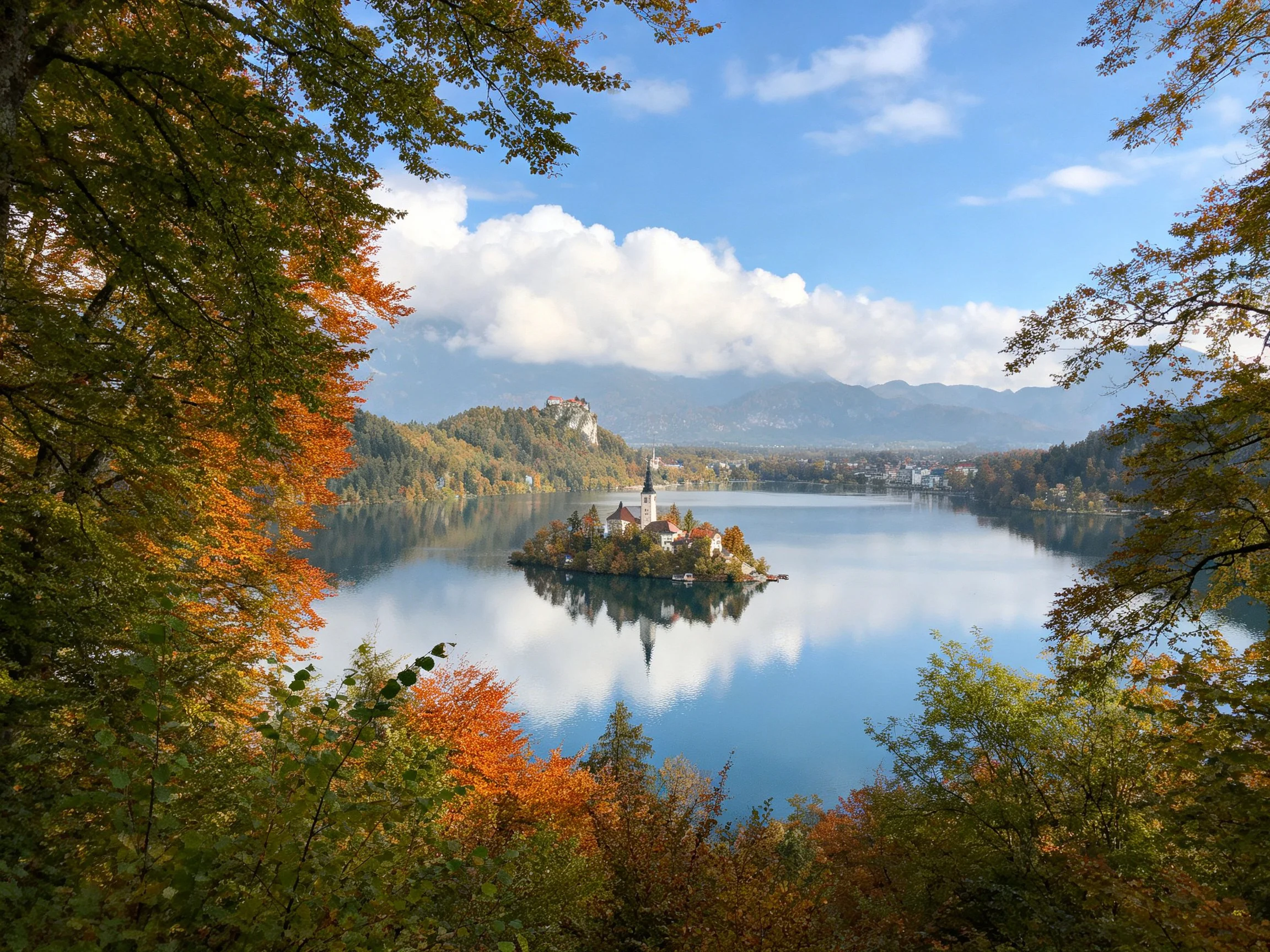 Autumn-hued trees frame Lake Bleds island church