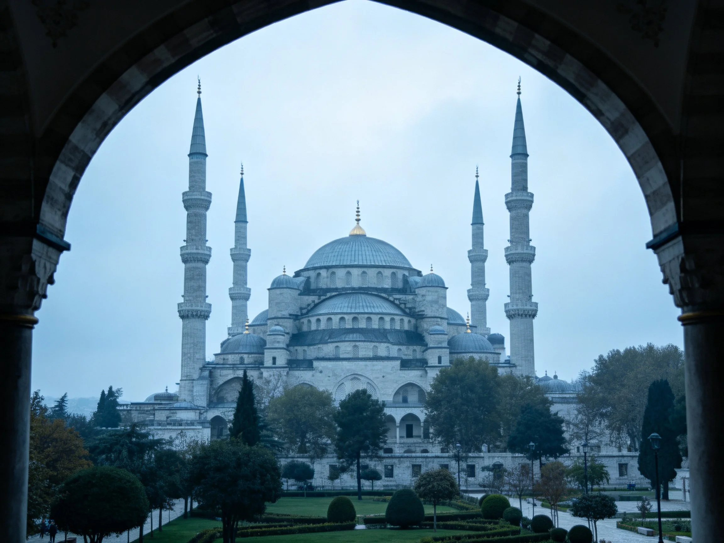 Blue Mosque viewed through stone archway with six minarets