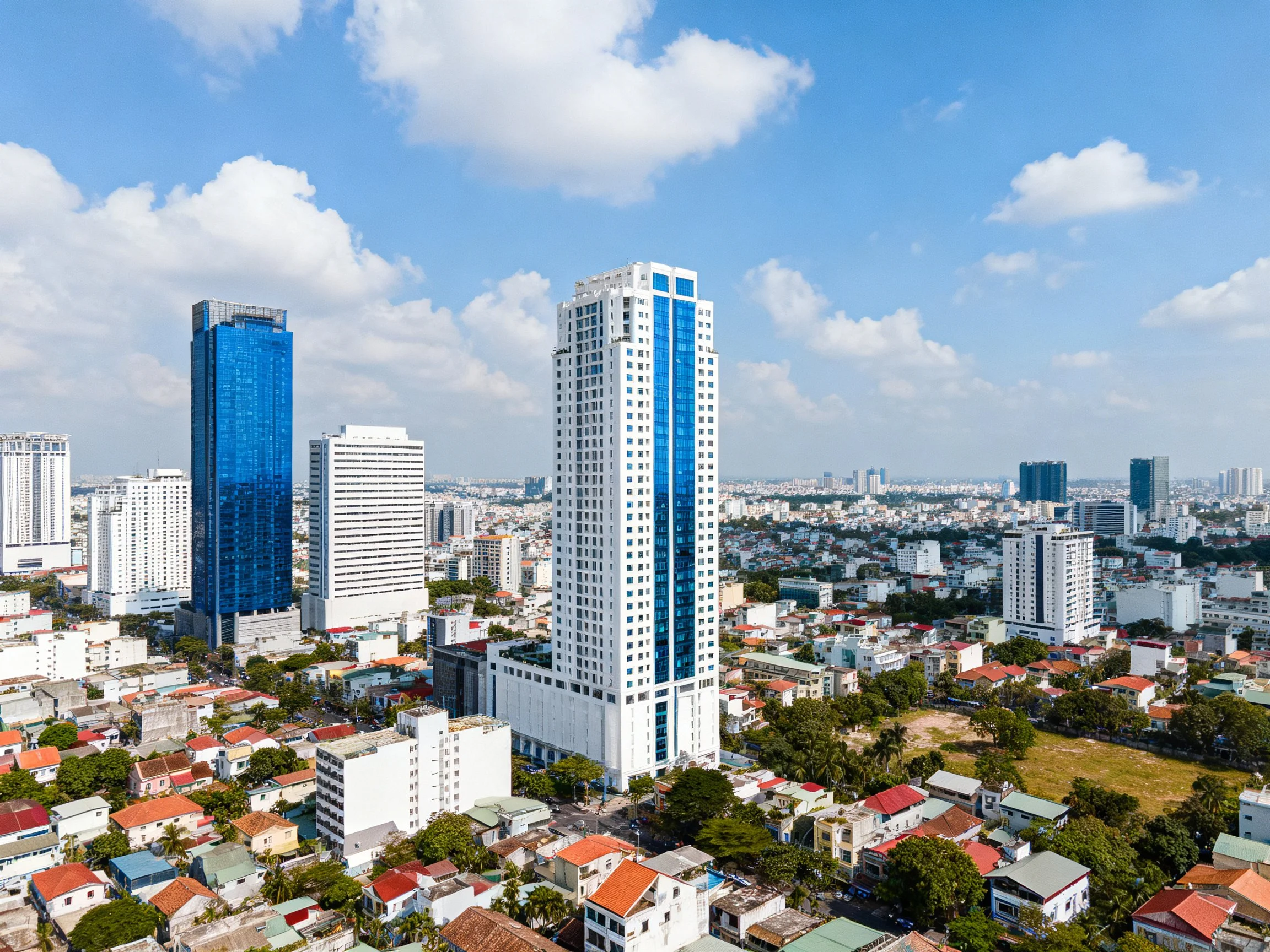 Blue and white skyscrapers tower over mixed city buildings