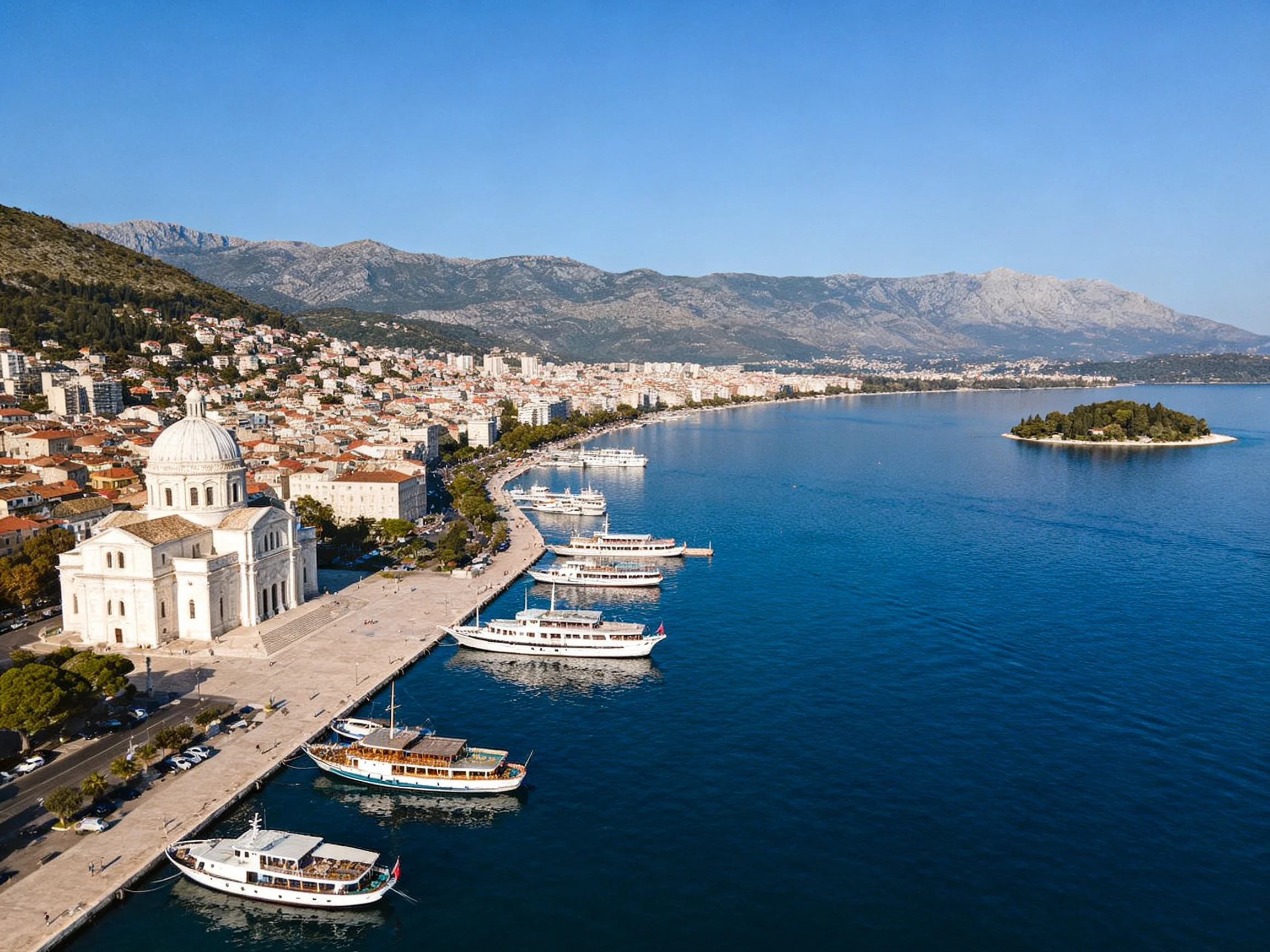 Coastal Town with White Cathedral and Docked Boats
