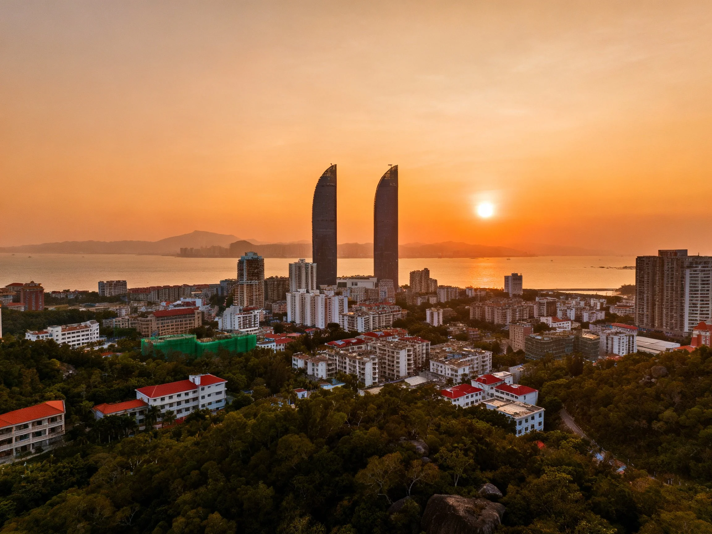 Coastal city sunset with twin skyscrapers and greenery