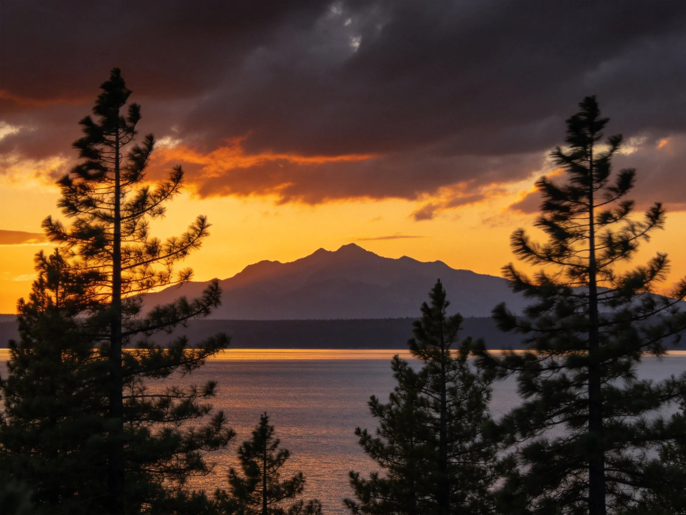 Dramatic Sunset Over Mountain Lake With Silhouetted Pines