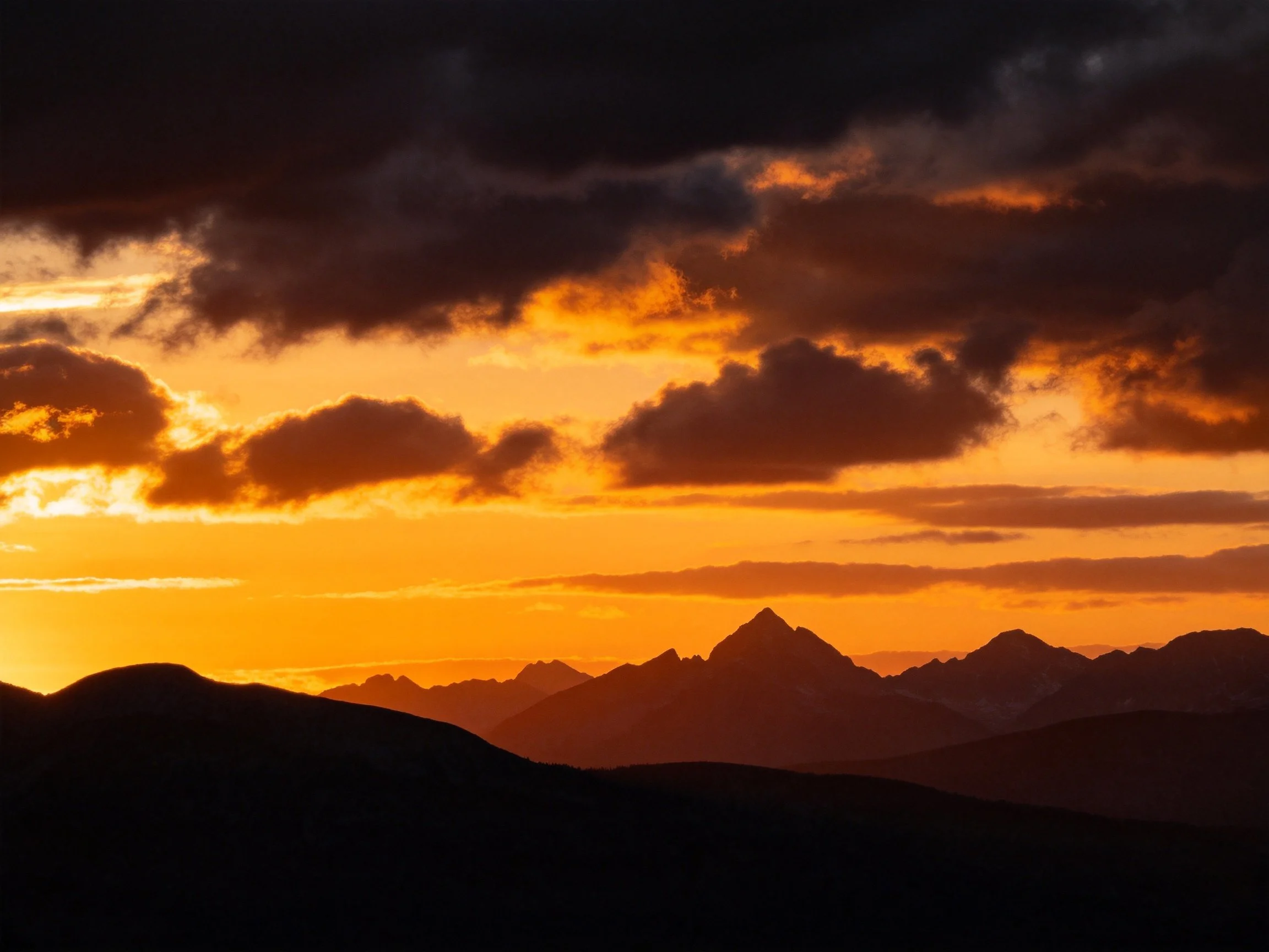 Dramatic Sunset Over Mountain Silhouettes With Golden Sky