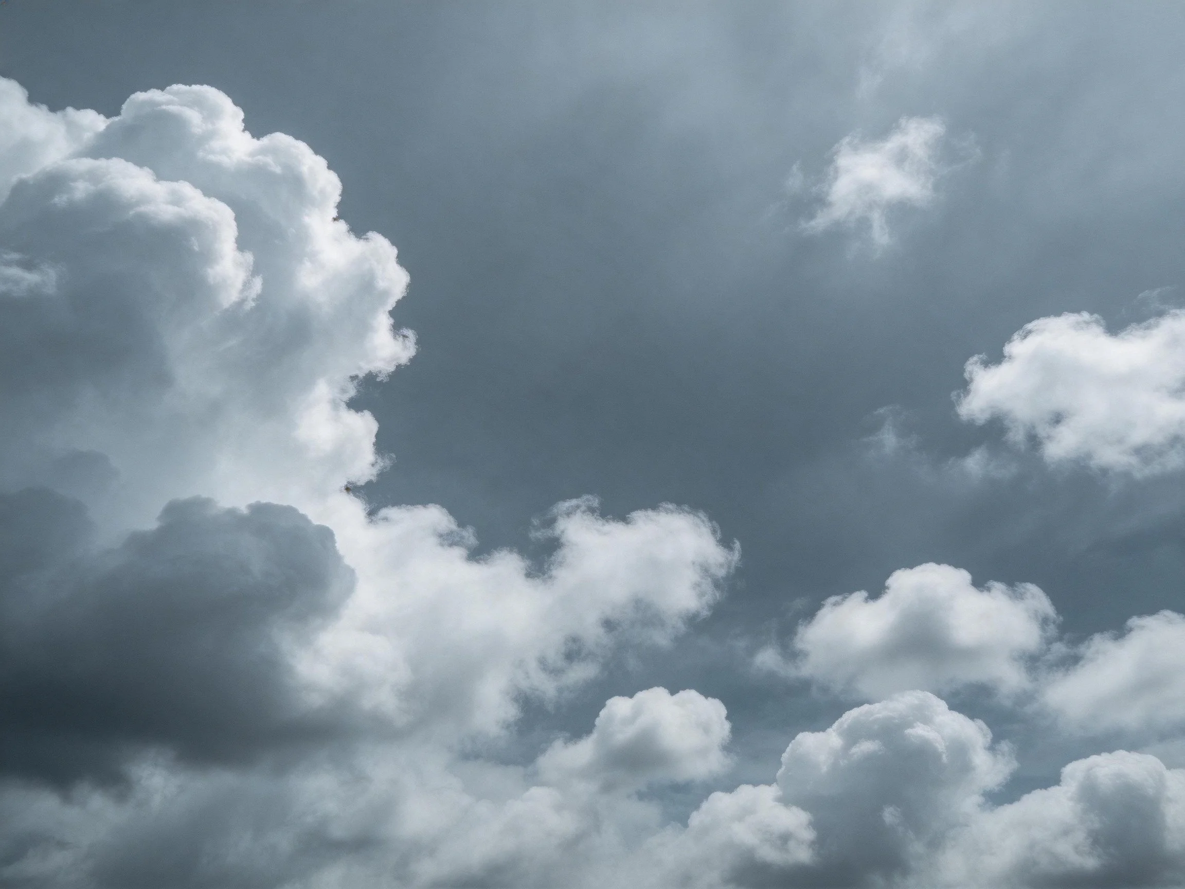 Dramatic sky with thick, varied white and dark gray clouds