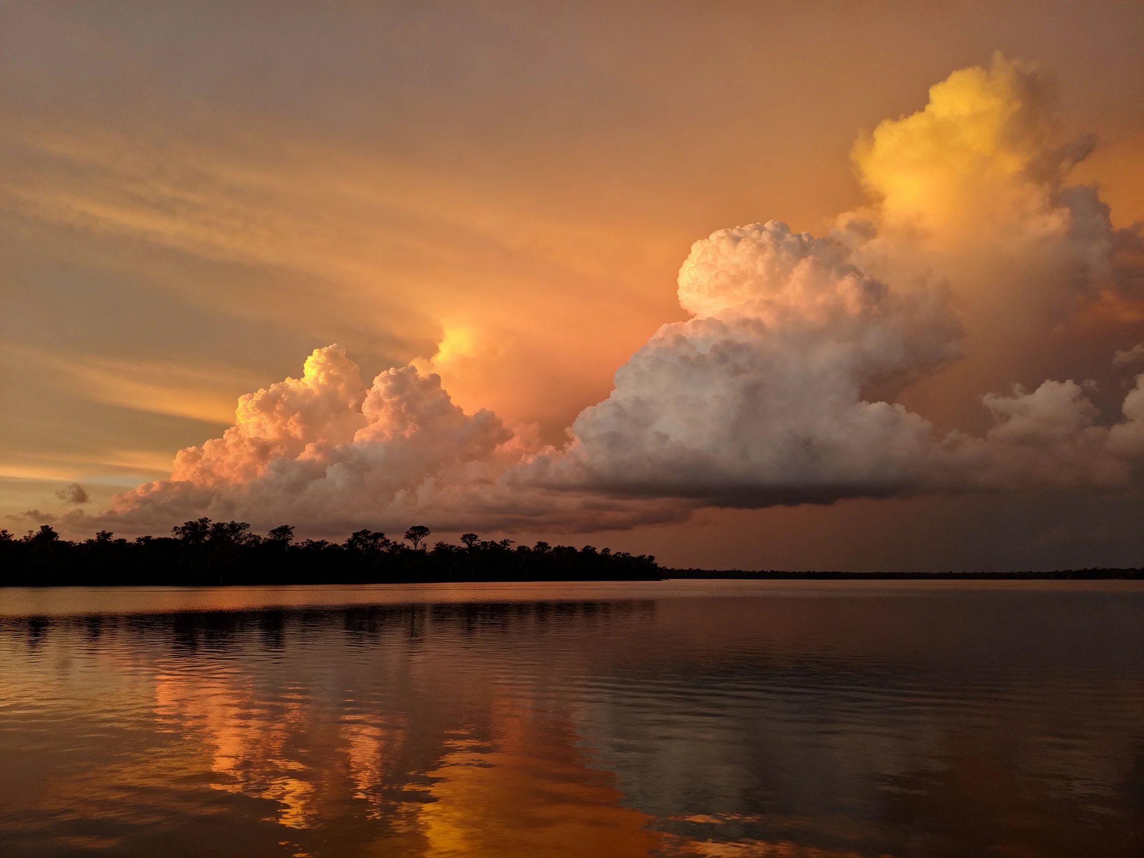 Dramatic sunset clouds reflecting in calm waters