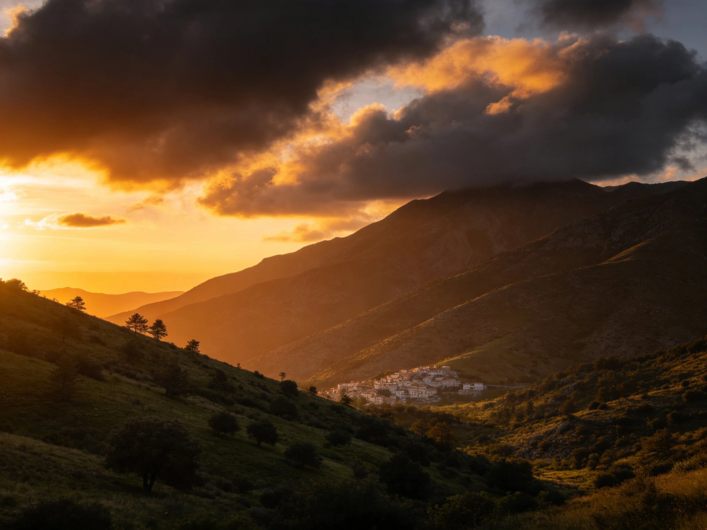 Dramatic sunset over mountain valley with golden light