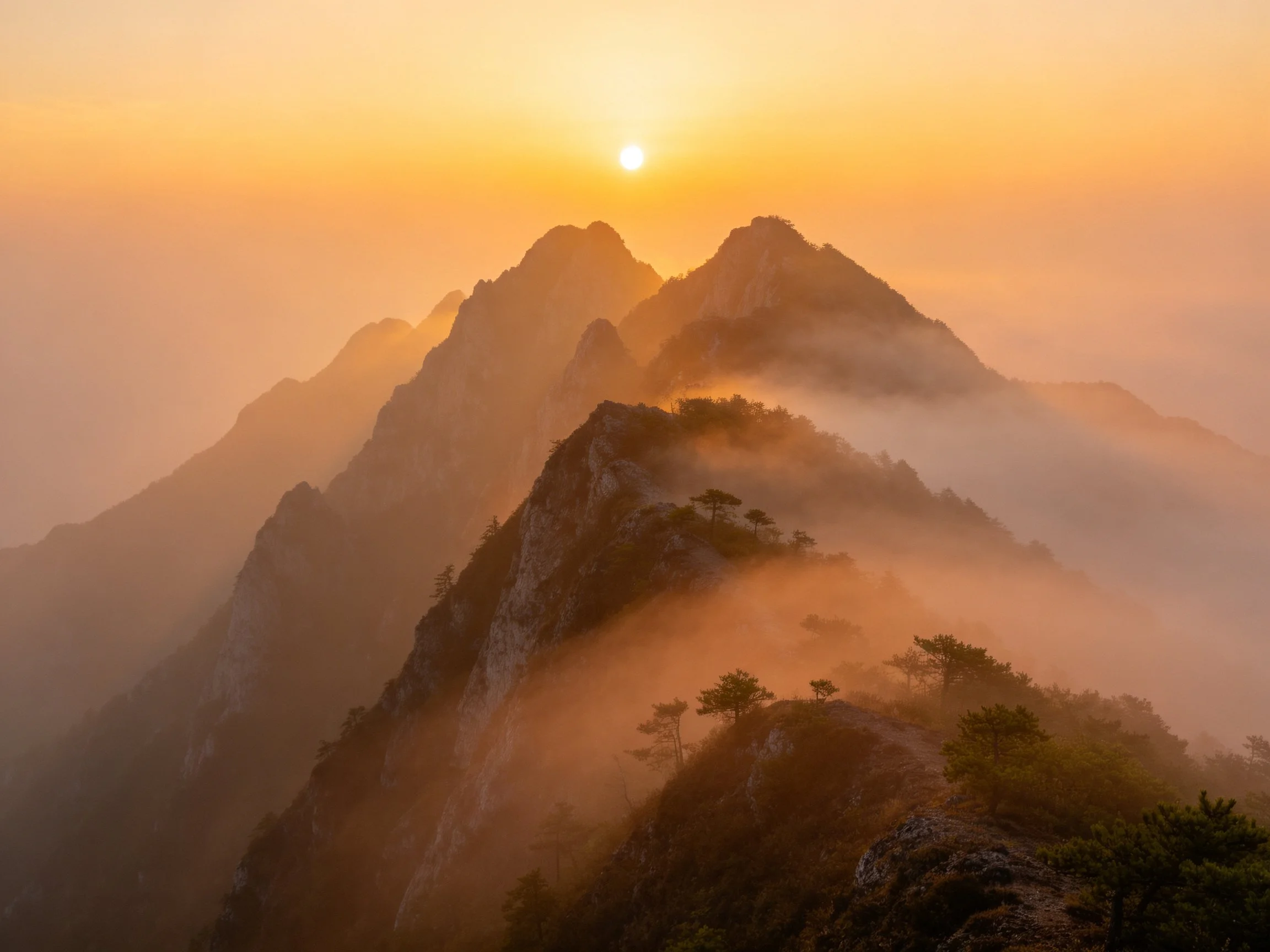 Golden Sunrise Over Misty Mountain Peaks