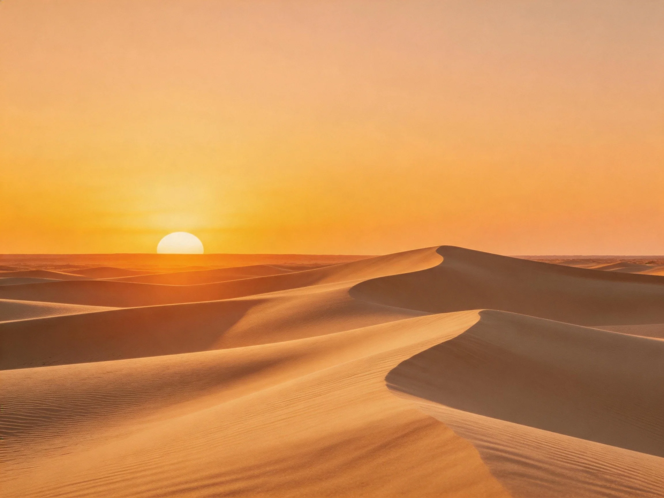 Golden sand dunes bathed in an orange-hued sunset