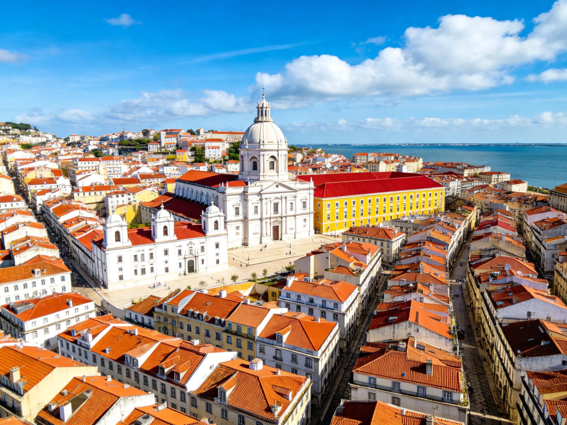 Historic European city with white cathedral and terracotta rooftops