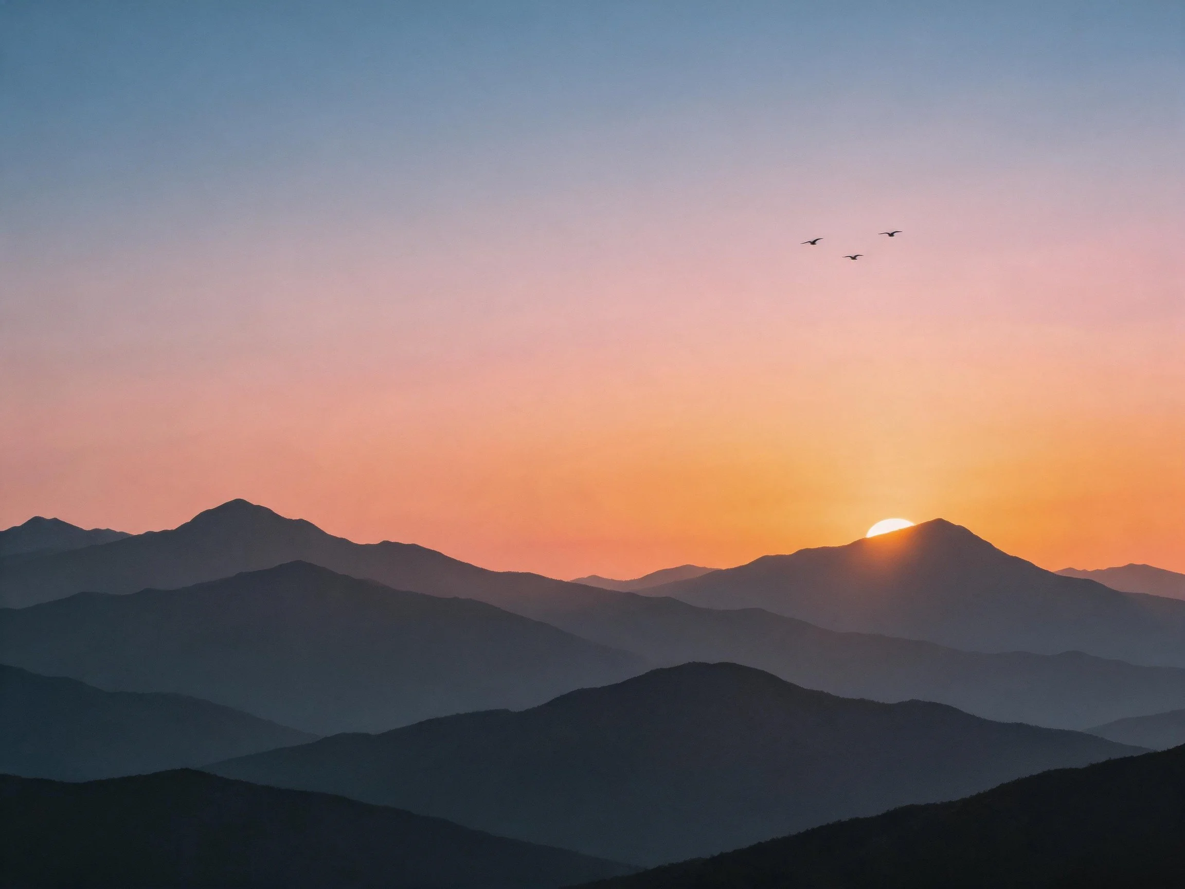 Layered mountain silhouettes against a vibrant dawn sky with flying birds