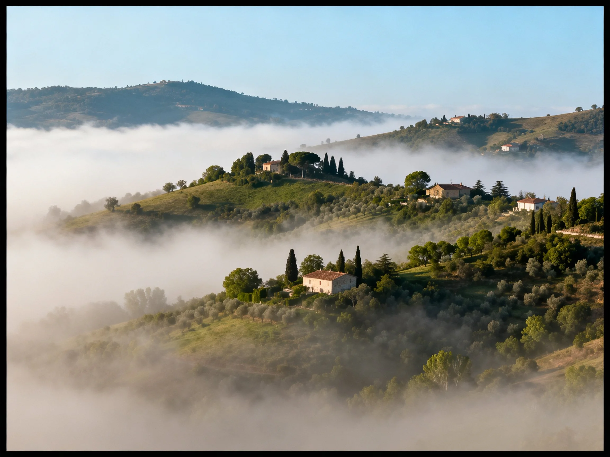 Mist-covered rolling hills with scattered cottages and trees